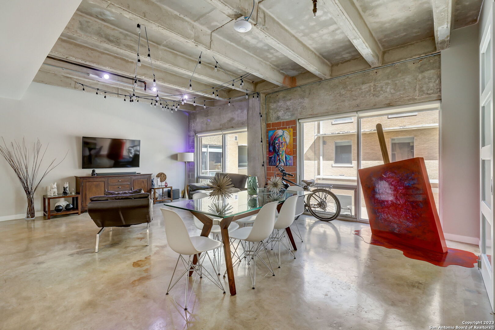 Stunning modern/industrial 3-bedroom loft located at the St. Benedicts Lofts in Southtown within walking distance to The Friendly Spot, Hot Joy, Little Em's, The Jewel, Titos and so much more! This unit boasts an open layout enveloped in natural light with gorgeous stained concrete and tile flooring throughout. The kitchen sits in the heart of the space featuring white Bosch appliances, a beautiful tile backsplash and opens to the spacious living area - perfect for entertaining. The primary suite is tucked away for privacy with an over-sized walk-in closet, full bath and fabulous views. Your secondary bedroom is just down the hall with a full bath adjacent and the third bedroom can also be used as a study/home office. The condo has many amenities including a 24-hour gym, additional storage space (#303), 2 covered parking spots (one with electricity ready for a car charger) and a sparkling pool with a grill area!