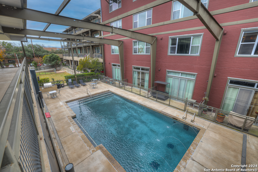 If you are looking for a contemporary yet trendy space to call home, the Judson Candy Factory Lofts is the place for you!  Prime location near the San Pedro Creek Culture Park, Phase 2 Riverwalk area, and King William District.  Walking distance to So-Flo Market H-E-B, many eateries and shopping!  All are within minutes of the downtown area.  This condo is located on the upper floor of Building 3 and is where industrial meets chic. Washer + dryer + fridge will all convey.  Many amenities include:  gated premises, security features, 2 dog parks, dog grooming station, pool, BBQ area, extensive gym, bicycle racks, large climate controlled private storage space, assigned covered parking with designated guest parking lot, and a spectacular rooftop lounge area with amazing views of the downtown skyline. This 1/1 unit is exquisite.  Open floor plan with high ceilings that boasts a loft style feel including a covered patio with views of the Hemisfair. It is all the space one might need to fully enjoy the comforts of this historic building.