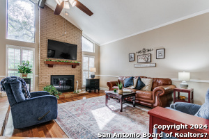 Set in a prime Northcentral San Antonio location, this bright and airy townhome offers a peaceful and convenient living experience. The elegant interior is adorned with a spacious living quarter set under high ceilings that feature stained wooden beams. The high ceilings and large windows create a home full of character, flooding natural light into the main areas and showcasing beautiful views of the serene community. The galley-style kitchen features warm white cabinetry, granite counters, built-in appliances, a charming window over the single-basin sink, and recessed lighting. The spacious dining room is set between the living and kitchen areas for a continuous flow that promotes entertaining. It hosts a gorgeous glass front door framed by large windows that present a sense of grandeur and welcome you to the private back deck. The outdoor space serves as a secluded outdoor oasis, where you'll enjoy fresh air while you sip your morning coffee or relax at the end of a long day. French doors at the front of the home guide you to the primary suite, complete with grand high ceilings and an ensuite bath with a dual vanity and a charming stone-covered walk-in shower. The secondary bedrooms share a well-appointed full bath and are generously sized, one of which is equipped with functional built-ins. The established community offers a private and tranquil vibe with a sparkling pool just outside your front door, built with beautiful stonework and showcasing many mature, well-manicured trees that serve as a canopy over the common spaces. The highly sought-after location places you within quick proximity to USAA, Medical Center, I-10, 410, 1604, The Rim, La Cantera, and just minutes to downtown. Come view all that this elegant townhome has to offer!