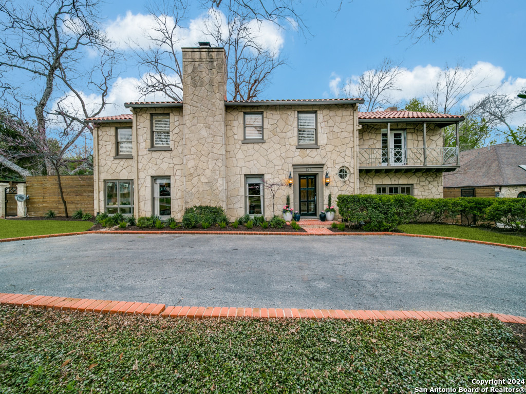Welcome to a piece of Olmos Park history! This remarkable 1940s stone home, believed to be crafted by the renowned H.C. Thorman, offers a unique blend of classic charm and modern potential. Situated on a spacious corner lot, this residence features a rare 5 bedrooms, 3.5 baths, and captivating niche spaces that add character to its timeless design.    Step into luxury as you discover a master suite with an attached library/office, complete with a private balcony overlooking the front yard-a perfect retreat for quiet moments and inspiration. The home also showcases a glassed-in sunroom with three walls of windows providing stunning views of the front and back yards, creating a seamless connection with nature.    The understated yet elegant formal dining room invites you to host memorable gatherings, complemented by the backdrop of lush greenery and natural light.  The living room has 1 of the 3 fireplaces located on the property. As you explore the property, a refreshing swimming pool awaits on the large corner lot, offering a private oasis for relaxation and entertainment.  The outdoor fireplace offers an opportunity to warm up  on chilly fall and spring days.    An unexpected surprise awaits with a spacious room, featuring a fireplace, pool table, poker table, and TV. This versatile space adds a layer of entertainment and relaxation to the home, creating a perfect spot for gathering with friends and family.    Practicality meets convenience with a circular driveway and a lengthy private driveway accessible through an electric gate on the side street. Parking is never an issue, providing ample space for family and guests.    While the house has good bones, it presents an exciting opportunity for a new owner to bring their personal touch and refresh this timeless gem. Unlock the potential of this historic residence, blending the charm of the 1940s with the comfort of modern living. Don't miss the chance to make your mark on this piece of Olmos Park's legacy!