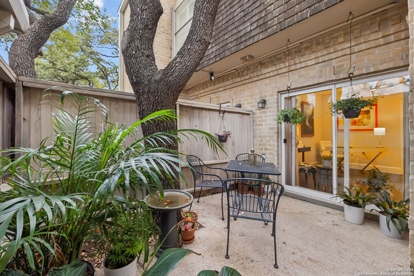 Welcome to 7731 Broadway #A10, a beautifully updated two-story condo in the desirable Dijon North community of Alamo Heights. Offering over 2,000 square feet of living space, this 3-bedroom, 2.5-bath residence combines comfort, convenience, and low-maintenance living in one of San Antonio's most sought-after locations. Hardwood floors, high ceilings, and abundant natural light enhance the spacious interior, while the inviting living room with wet bar creates an ideal setting for entertaining. The well-appointed kitchen opens to a private fenced patio and is complemented by a breakfast area, walk-in pantry, and formal dining room. Upstairs, the expansive primary suite features a walk-in closet, dual vanities, generous storage, and a separate tub and shower. Two additional bedrooms, a full bath, and upper-level laundry provide a functional and flexible floor plan. Residents enjoy controlled access, mature trees, a community pool, on-site management, and a lock-and-leave lifestyle. HOA dues include trash service, pest control, common area maintenance, exterior maintenance, and condominium management. Additional highlights include a two-car covered carport and a recently installed three-zone HVAC system (April 2024). Ideally located along the Broadway corridor near shopping, dining, entertainment, downtown San Antonio, the Pearl, San Antonio International Airport, and major medical centers, this Alamo Heights condo offers exceptional value, space, and convenience within Alamo Heights ISD.