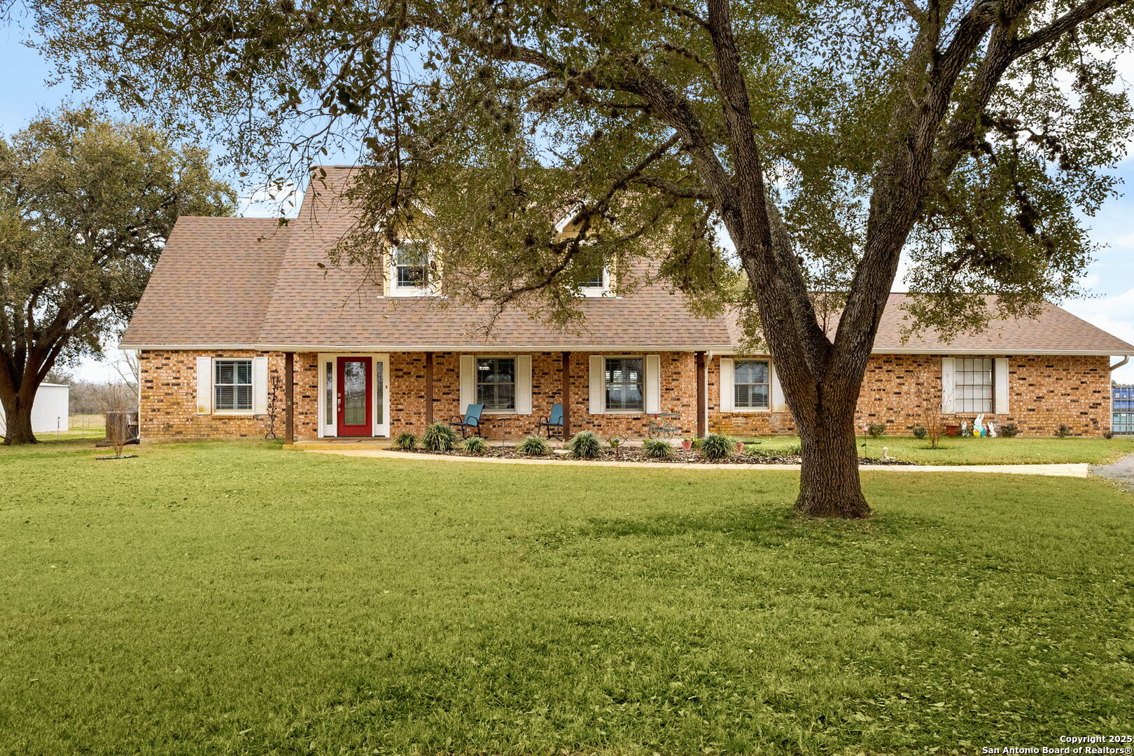 This stunning 3-bedroom, 2.5-bath two-story brick home sits on 2 beautiful acres with towering trees and easy access to town. Completely renovated down to the studs in 2020, this home is packed with high-end finishes and thoughtful upgrades. The gourmet kitchen features quartz countertops, a gas cooktop, double KitchenAid ovens, and wood flooring throughout. Custom tilework, unique vanities, and designer touches make this home truly one of a kind. Energy-efficient solar panels and all-new Anderson windows provide long-term savings. A well with a sprinkler system complements the coop water supply to the home. The spacious primary suite and large secondary bedrooms offer plenty of comfort. Move-in ready and built to impress!