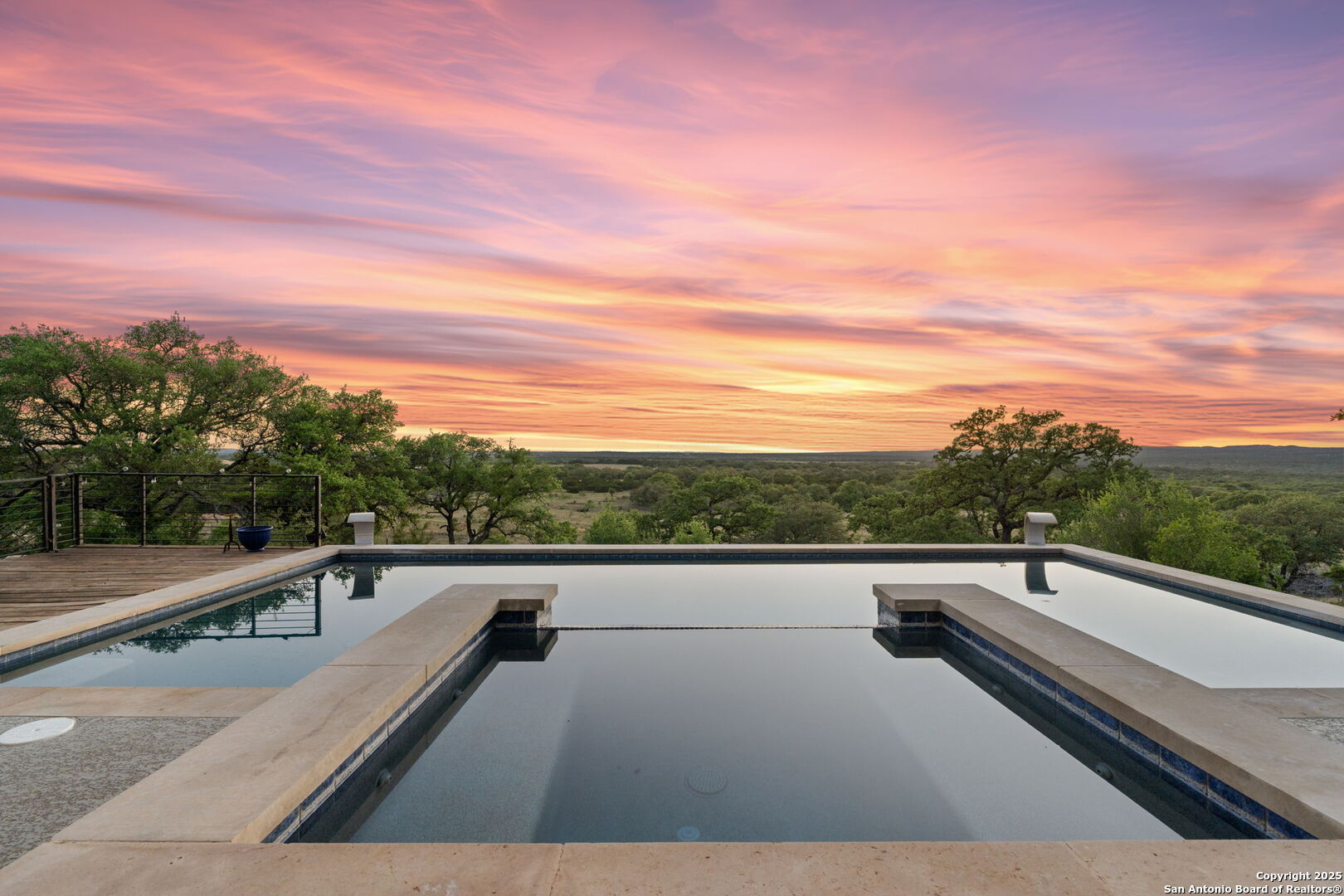 Hill Country Retreat on 25 Acres minutes from Johnson City, Fredericksburg, and local wineries. Less than an hour to both Austin and San Antonio - this 25-acre estate offers spectacular panoramic views of the Texas Hill Country. The home features 4 bedrooms, including a flexible space ideal for a guest room, game room, or home gym. An additional bathroom can easily be added upstairs. The open-concept living and kitchen area is perfect for entertaining, and the dedicated office provides a quiet space to work or create. Step outside to your private pool and hot tub, perfectly positioned to take in the sunset views. Enjoy established riding and UTV trails throughout the neighborhood, all within a gated neighborhood for added privacy and peace of mind.