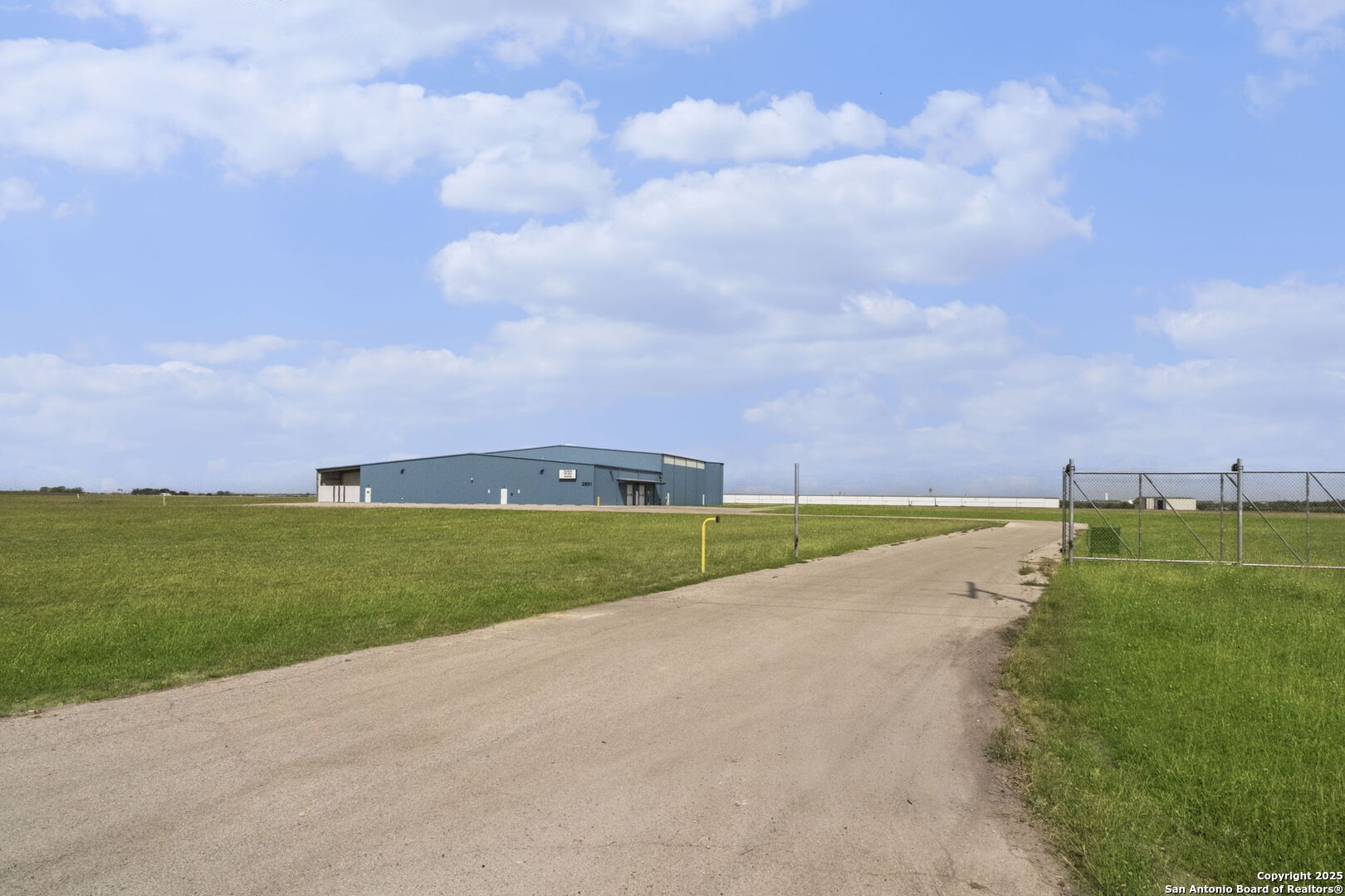 Presenting a prime 9,600 square foot commercial and industrial property for lease, with an optional 10,000 square foot expansion, ideal for businesses in warehousing, light manufacturing, and production. This fully secured, gated facility offers a seamless blend of professional office space and a climate-controlled warehouse, featuring a welcoming reception area, nine private offices, and multiple restrooms. The expansive warehouse includes multiple electrical drops, air compressor lines, and is production-ready with an 800 amp three-phase power system, two high-voltage sub-panels, and three low-voltage sub-panels. Climate control is ensured with five HVAC units (two five-ton, one seven and a half-ton, and two ten-ton units). The property also includes two electric motorized roll-up doors, two manual drive-in doors, a 900 square foot outdoor covered storage area, two commercial-grade water fountains, and a highly functional layout designed for efficient office-to-warehouse operations.