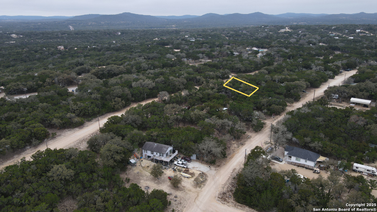 Discover your dream property just about 7 miles from Downtown Bandera! This beautiful, tree-filled residential lot is perfectly situated near Medina Lake and the scenic Medina River, providing a tranquil escape into nature. Enjoy watching the local wildlife, including Whitetail and Axis Deer, right from your future home. The neighborhood boasts an impressive array of amenities designed for relaxation and recreation. With access to both the lake and the river, you can indulge in a variety of water activities. Additionally, you can enjoy leisure time at the Putt Putt Golf course, take a dip in the community pool, or let the kids have fun at the playground. This prime location is perfect for a weekend getaway, a charming Hill Country homestead, or as a fantastic investment property. Don't miss this opportunity to own a slice of paradise in the heart of Texas Hill Country. Lot dimensions are approximate, based on county data.