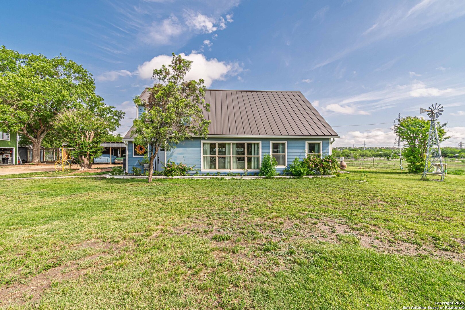 Welcome to this beautifully remodeled property on the northeast side of town, sitting on a spacious 1-acre lot! The main house offers 1,510 sq ft of updated living space, featuring new vinyl flooring throughout, a gorgeous wood kitchen with stone countertops, and a cozy layout perfect for modern living. The primary bedroom is conveniently located downstairs for added comfort and privacy.    Outside, there's plenty of room for family recreation and outdoor fun. The property includes a 988 sq ft garage, a 300 sq ft shop, a 288 sq ft guesthouse, a 720 sq ft carport, a 256 sq ft hay barn, and a 2,041 sq ft stable-perfect for those seeking space for hobbies, animals, or extra storage.    This is a rare opportunity to enjoy country-style living while still being close to city amenities!
