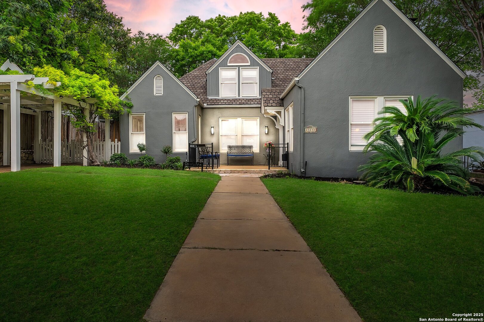 Welcome to this stunning historic gem nestled in the coveted Bluebonnet Hills neighborhood, right in the heart of Alamo Heights. Ideally located just steps from the McNay Art Museum and Alamo Heights High School, this charming home offers the perfect blend of timeless character and modern updates.    Inside, you'll find beautiful original hardwood floors, a thoughtfully renovated kitchen and primary bath, and full-wall custom bookcases in both the dining room and flex space - ideal for an office, library, or additional living area. Each of the three bedrooms features spacious walk-in closets, a rare and highly desirable feature.    Perfect for entertaining, the home boasts expansive flagstone patios, a well-shaded backyard, and plenty of parking for family and guests. A detached two-car garage with convenient alley access offers overhead storage and a finished office/studio space - ideal for working from home, hobbies, or a private retreat.    Don't miss the opportunity to own a piece of Alamo Heights history, updated for today's lifestyle!