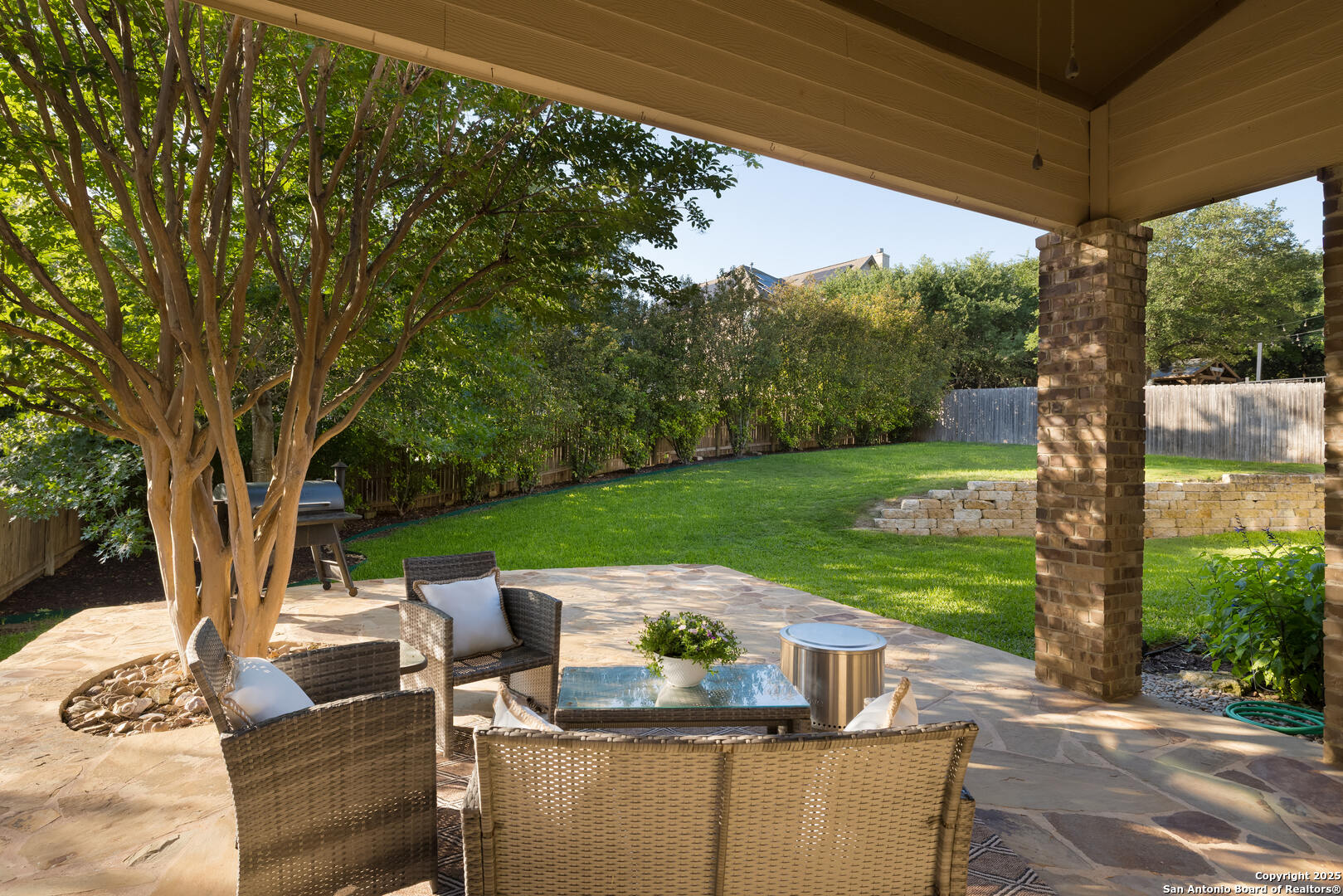 Covered Back Patio, Trees Provide Privacy in Yard