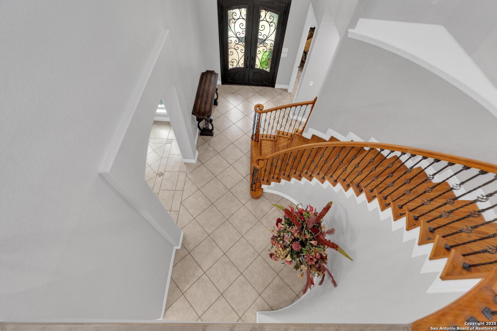Grand entry with iron staircase and tall ceilings