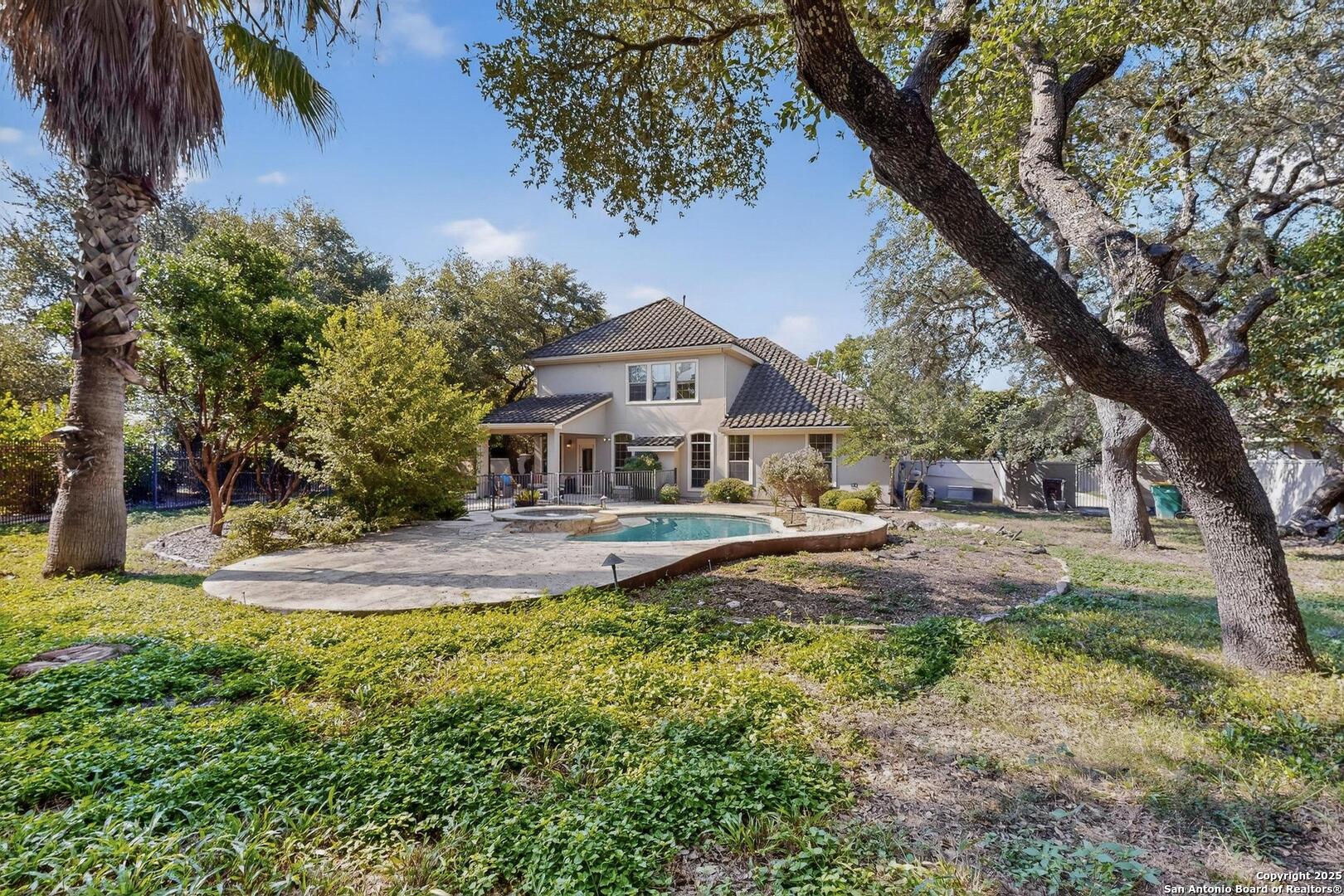 BACKYARD VIEW OF GARDENS AND POOL