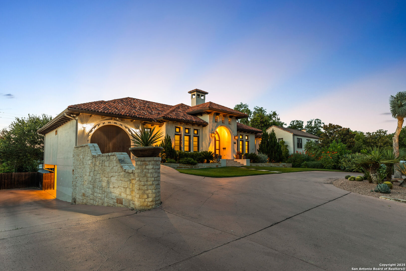 image shows driveway down to lower level garage