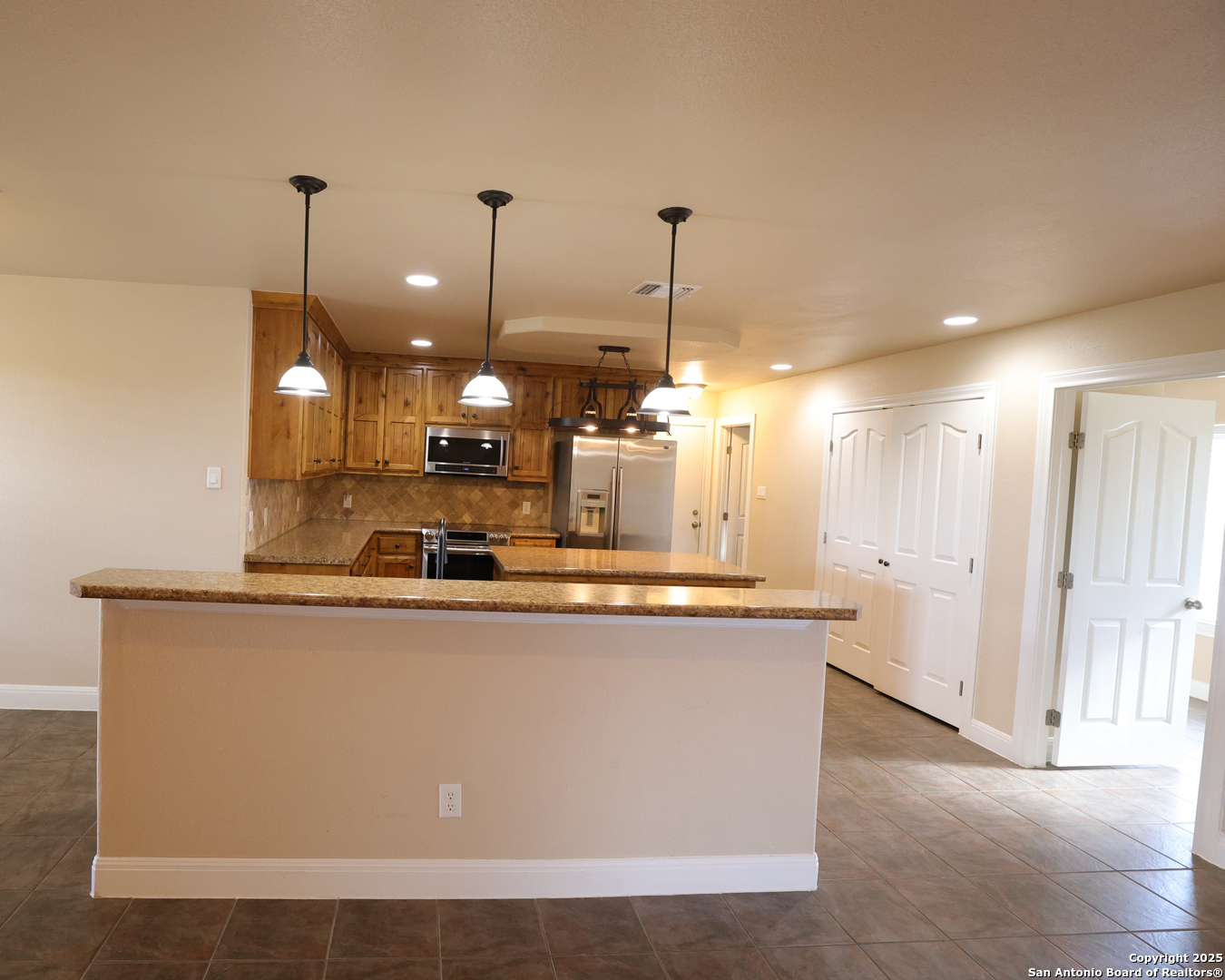 Kitchen view from the large L. Area, eat at bar