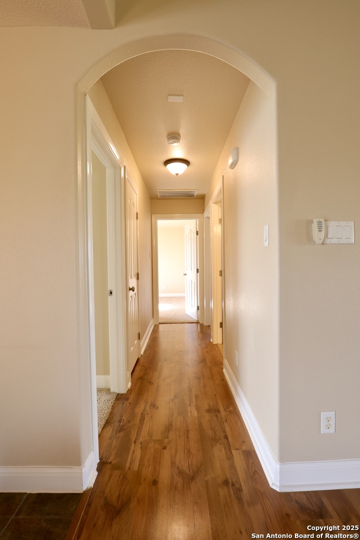 Hallway to secondary bedrooms, lg bath & hall clst