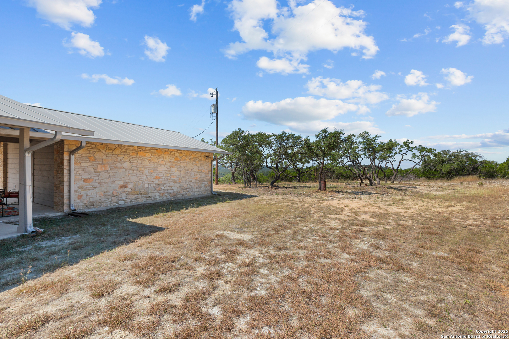The area where the trees are-good place for a pool