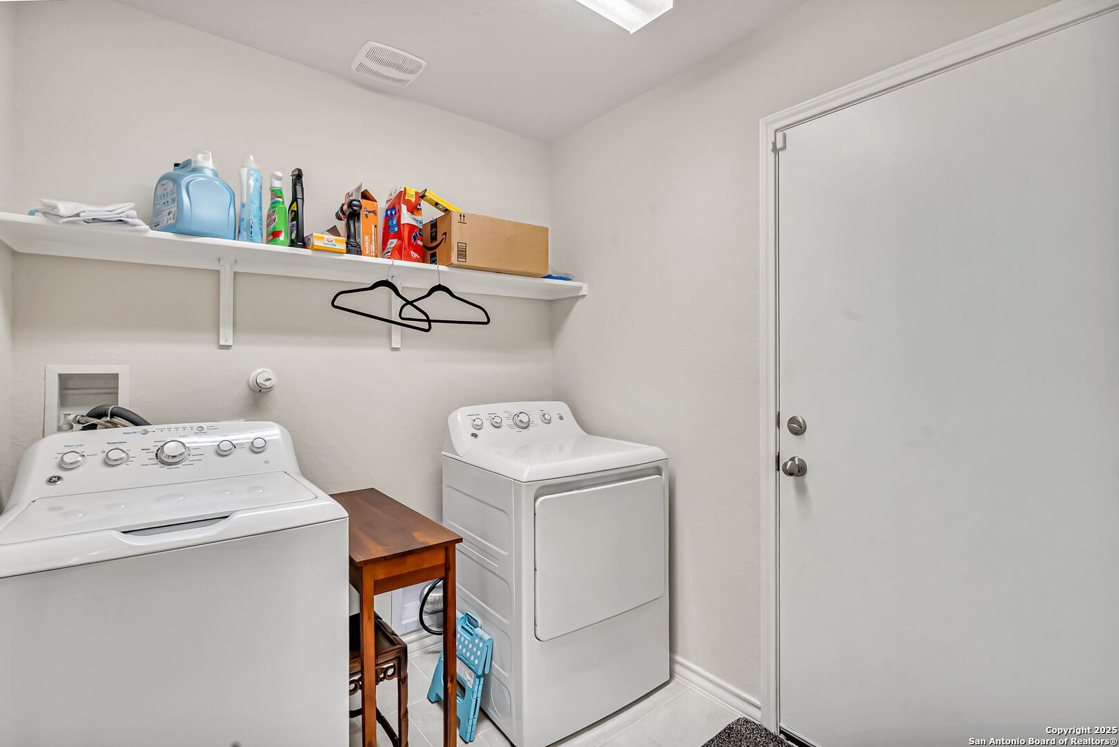 Laundry room leading to standard 2 car garage
