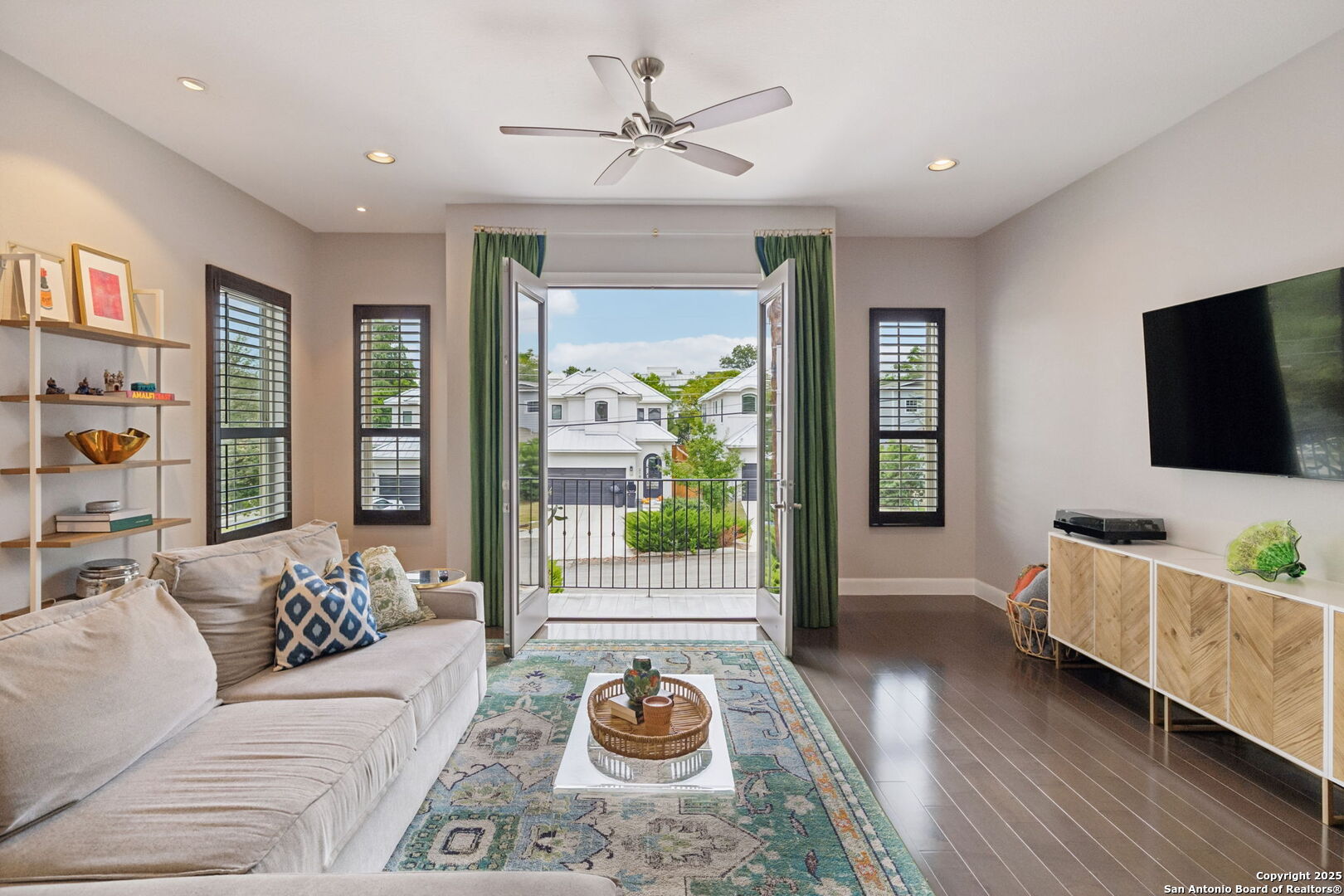 Stunning interior design and custom upgrades define this lock-and-leave Olmos Park townhome built in 2017, offering 3 bedrooms, 3 full baths, and 1 half bath. The open-concept living, dining, and kitchen space features wood flooring, quartz countertops, gas cooking, two wine fridges, and shutters throughout. The primary suite includes a coffee bar, dual vanities, separate shower and soaking tub, and a large walk-in closet. Each secondary bedroom offers an en-suite bath for privacy and convenience. Off the kitchen, a balcony overlooks the yard; on the ground level, a large patio with built-up grill opens to landscaped greenspace with sprinkler system, ideal for low-maintenance outdoor living. A two-car attached garage provides secure parking and storage.  Located in the historic enclave of Olmos Park, this residence combines neighborhood charm with easy access to San Antonio's most popular destinations. Rose Hip Market is just 0.3 mile (6 min walk) for fresh groceries, and Olmos Pluma Coffee Bar sits 0.9 mile away (18 min walk) for morning coffee. The San Antonio Zoo and Brackenridge Park are 1.0 mile (20 min walk), offering nearby recreation and green space. Within minutes, enjoy the Alamo Heights Dog Park (2.1 mi / 7 min drive) or explore dining and shopping at The Pearl District (2.6 mi / 9 min drive). The Methodist ER Alamo Heights (2.1 mi / 6 min drive) and San Antonio International Airport (5.1 mi / 12 min drive) provide everyday convenience for travel and healthcare access. Zoned to Alamo Heights ISD, this beautifully appointed home delivers refined design, thoughtful upgrades, and a connected, low-maintenance lifestyle in one of San Antonio's most desirable neighborhoods.