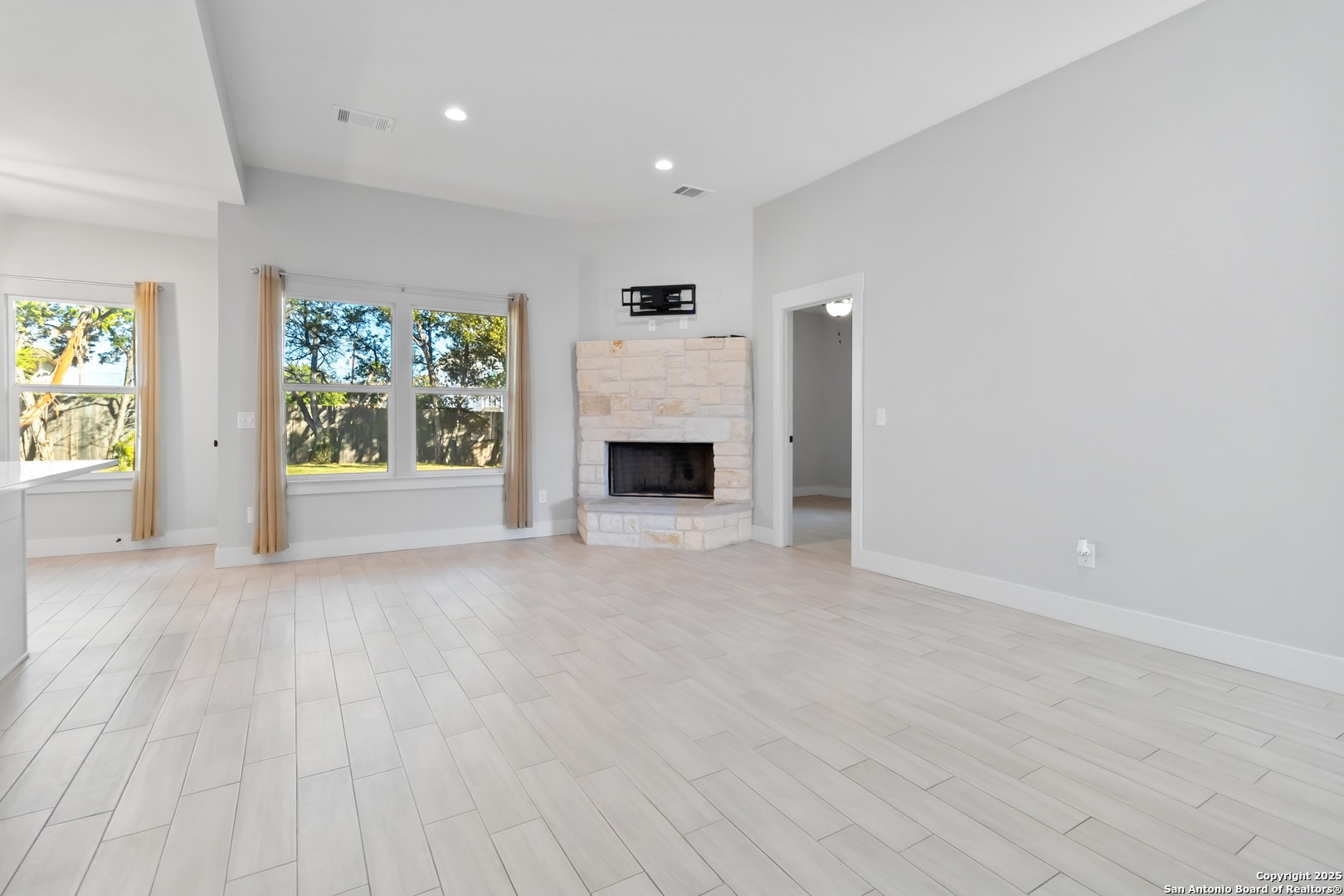 Living room w/ wood burning fireplace