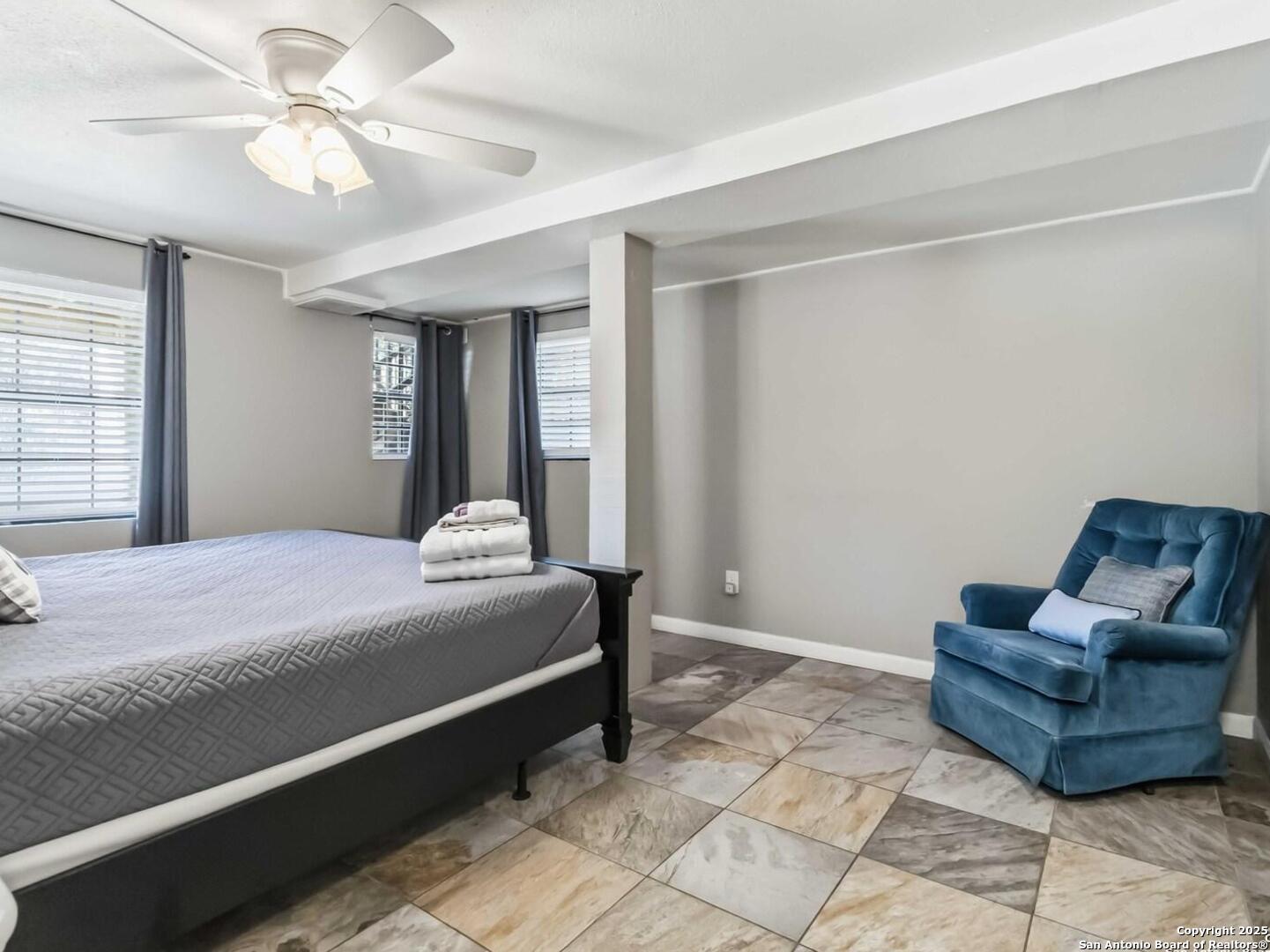 Primary bedroom with sitting area.