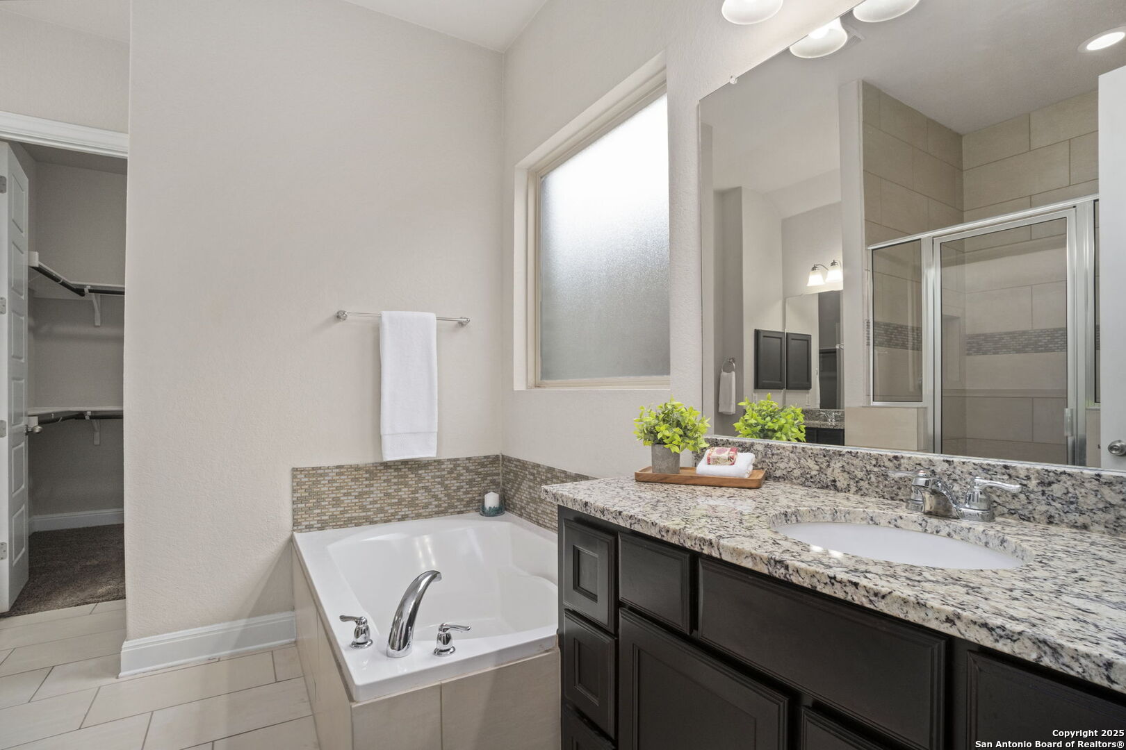 Dual Vanities, shower and garden tub.