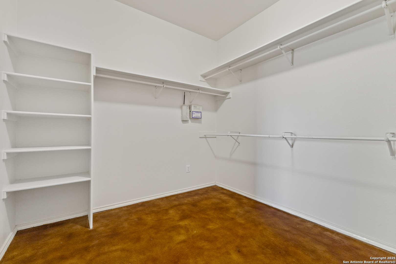 One of 2 primary bedroom walk in closets