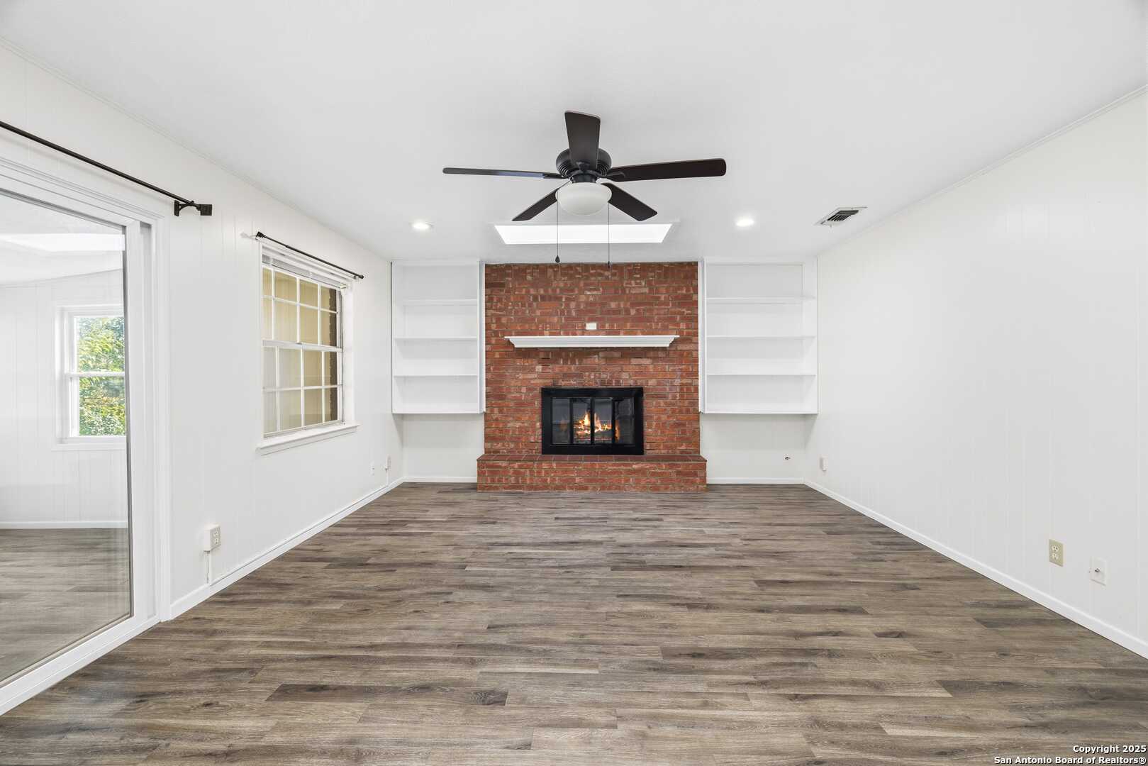 Family room w wood burning fireplace.