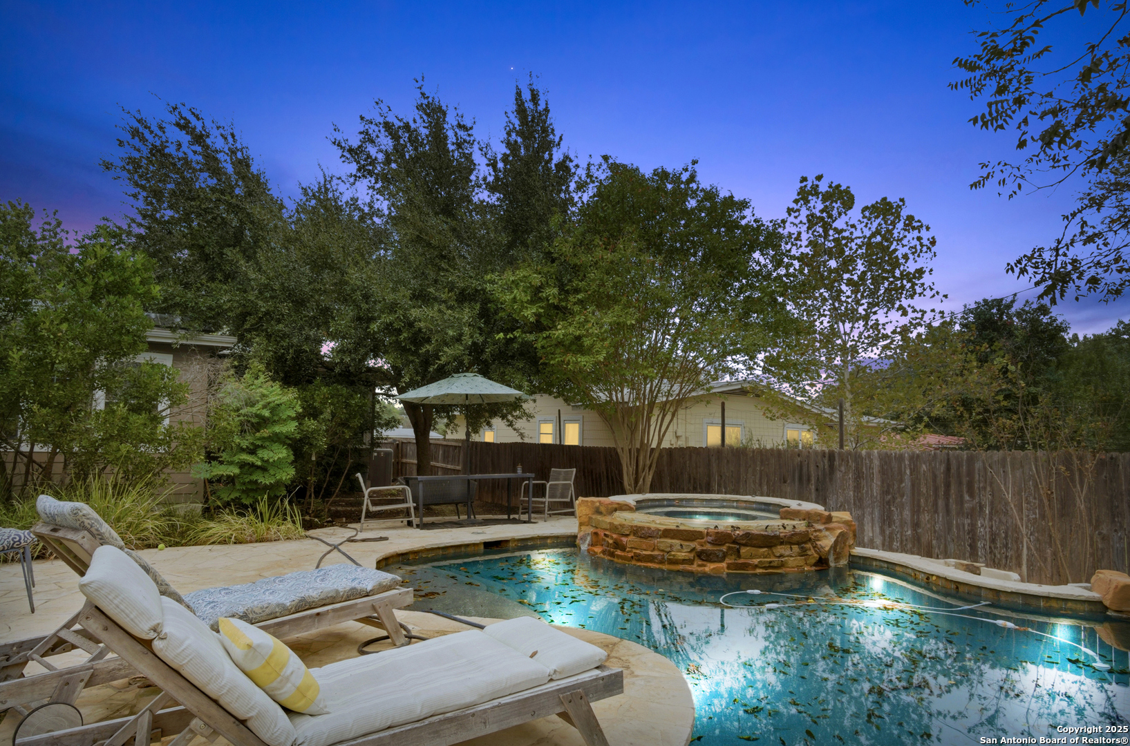 Stunning one-story residence nestled in the heart of coveted Terrell Hills - this bespoke 3-bedroom, 2-bath home delivers upscale living with thoughtful upgrades and outdoor resort-style amenities. An open floor plan flows effortlessly through two spacious living zones, one anchored by a cozy gas-burning fireplace - ideal for relaxed evenings or entertaining guests. The functional office/bonus room adds versatile space for work or play. The chef's kitchen is outfitted with premium gas range, full-size refrigerator & dishwasher, solid surface countertops and abundant cabinetry. A dedicated laundry room with washer and dryer hookups enhances everyday convenience.    The primary suite features a spa-inspired ensuite bath with walk-in shower, garden tub, double vanity and large walk-in closet - your private retreat. Step outside to your own backyard oasis: lush mature trees define the fenced yard, where a heated inground pool and adjacent hot tub/spa invite seasons-long enjoyment. A storage shed offers extra utility and the fenced garden area is perfect for cultivating organic vegetables, fruits and herbs. The two-car garage includes a dedicated Tesla charger and the home is equipped with paid solar panels, significantly enhancing energy efficiency and long-term value.    Located on a generous 10,600+ sq ft lot in Terrell Hills, this home blends modern amenities with outdoor luxury. Don't miss the opportunity to own a turnkey sanctuary that checks every box for comfort, style and smart investment.