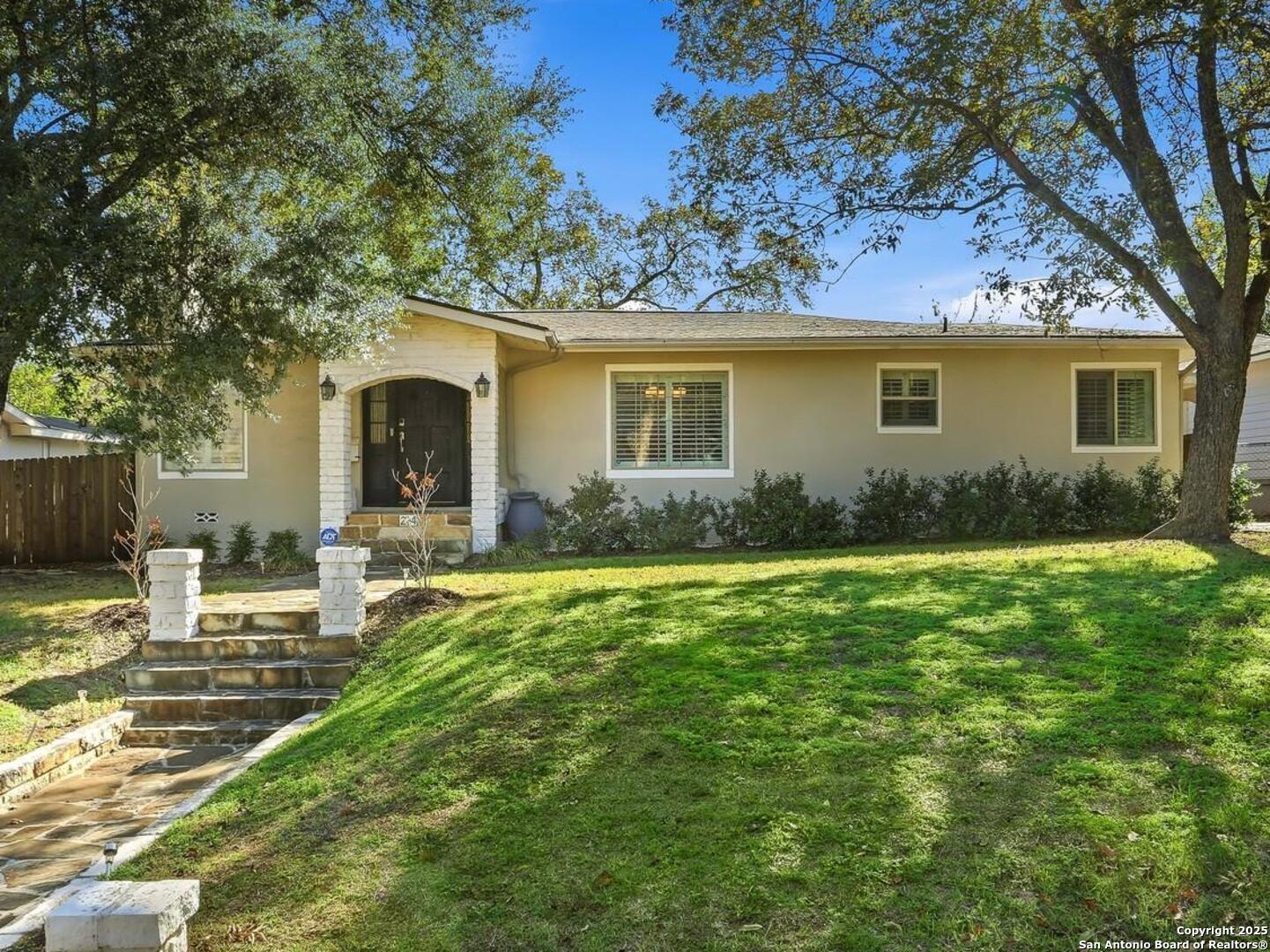 Welcome to this beautifully maintained 3-bedroom, 3-bath home located in a desirable and sought-after neighborhood with highly rated schools. This move-in-ready gem offers timeless character and modern comfort throughout. The inviting living room features a wood-burning fireplace, built-in shelving, and original hardwood floors. Natural light flows through the open dining area, highlighted by elegant plantation shutters.    The spacious kitchen, just off the dining room, boasts granite countertops, modern appliances, and a built-in pantry. The primary suite provides private access to the back patio, while the remodeled en-suite bath showcases a soaking tub, separate shower, and a generously sized walk-in closet. Each of the secondary bedrooms has its own updated bathroom, offering both privacy and convenience.    Step into the backyard oasis - a true entertainer's dream! Enjoy outdoor gatherings on the large deck, fire up the built-in stone barbecue pit on the separate stone slab area, or unwind surrounded by mature crape myrtles and a full privacy fence. The yard also includes a spacious storage shed and plenty of room to relax or play. A two-car carport with direct kitchen access completes this inviting home.