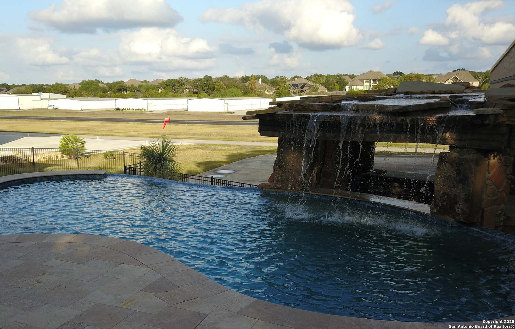 Heated pool with waterfall