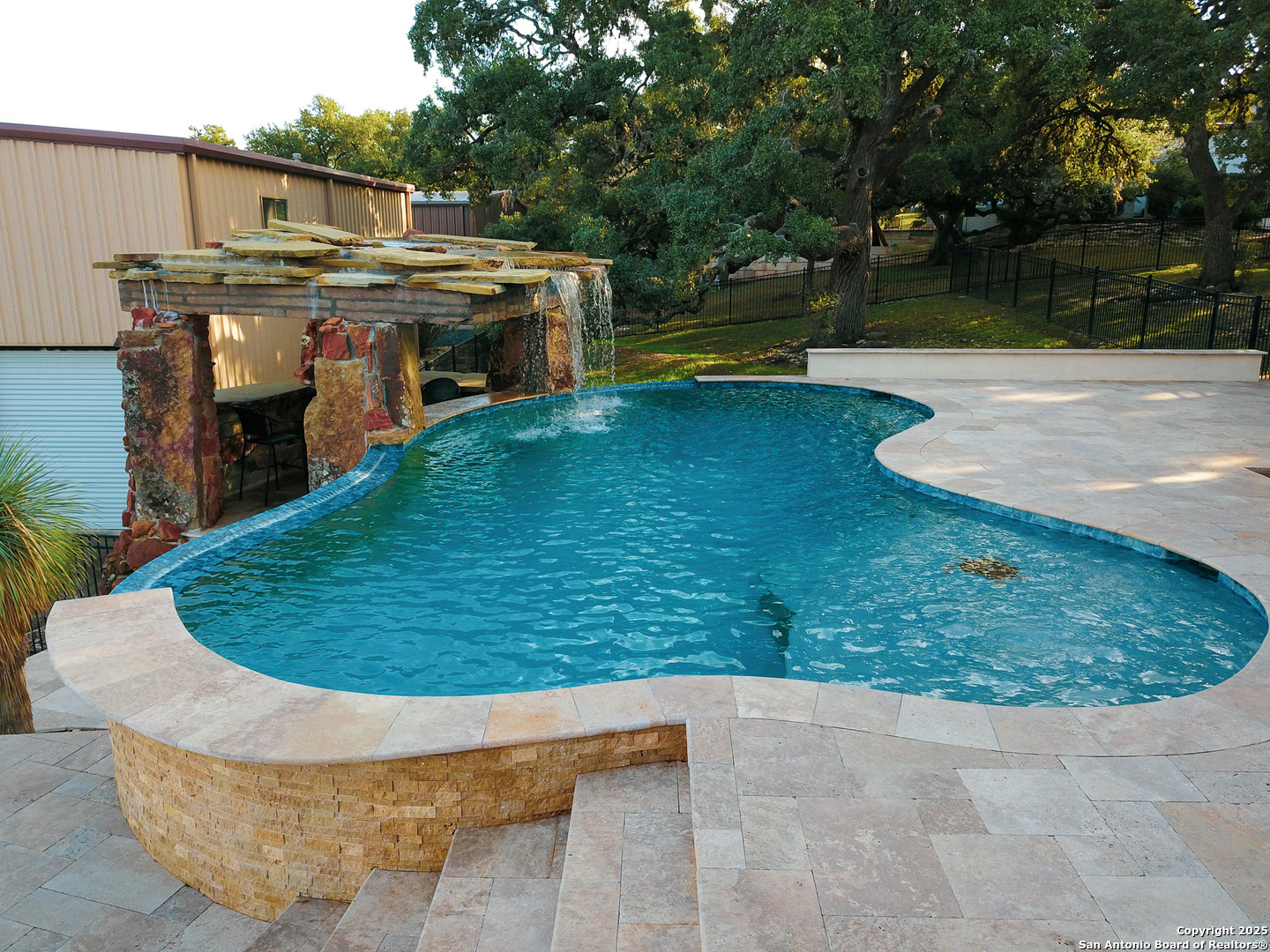 Heated pool with waterfall