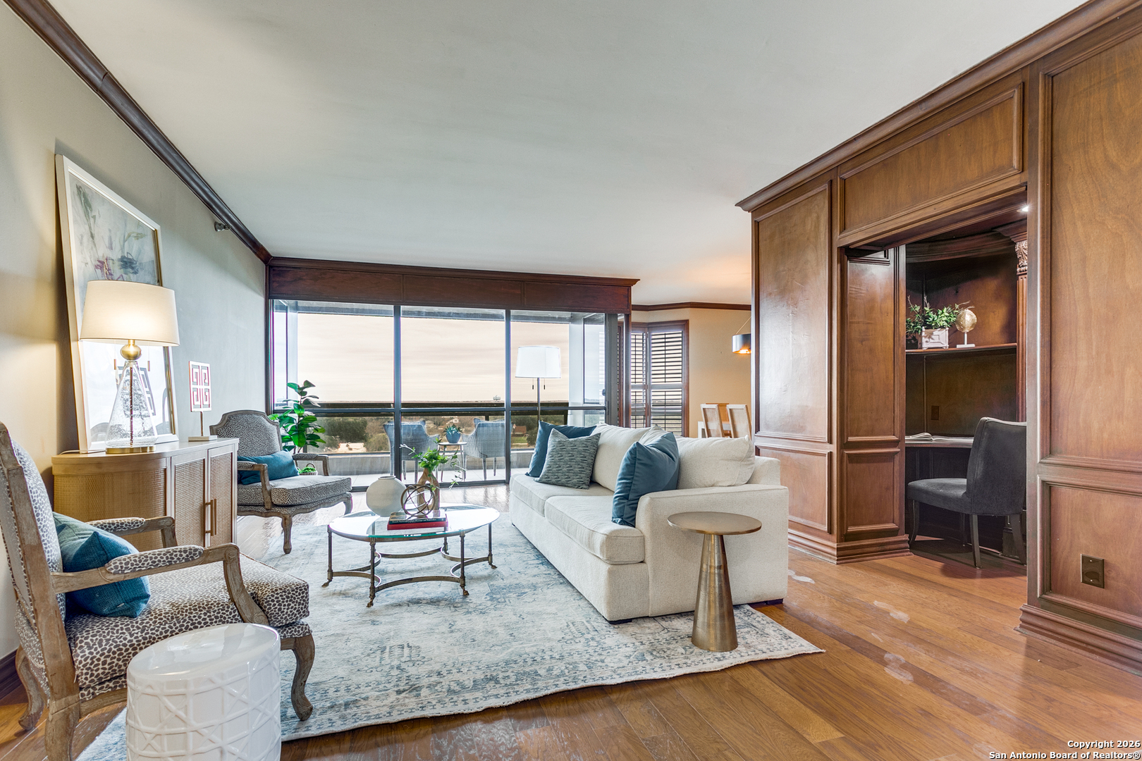 Enjoy beautiful, unobstructed views towards downtown and to the east from this luxurious high-rise condominium. The rich, wood flooring and wood paneling details provide a warm backdrop for this home. The spacious living room has access to a covered balcony and is open to the formal dining area. A charming study nook features a built-in desk, storage and bookcases for a handsome addition to the living area. The eat-in kitchen has ample storage, stainless appliances and the breakfast area has access to a second balcony. The primary suite has an suite bathroom with walk-in shower and double vanity plus a generous walk-in closet with storage solutions. Second bedroom and full bath. Louvered shutters, in-unit laundry room, and 2 parking spaces in garage are more amenities to enjoy in this condo. Building features tennis court, pool, spa, work-out room and more!