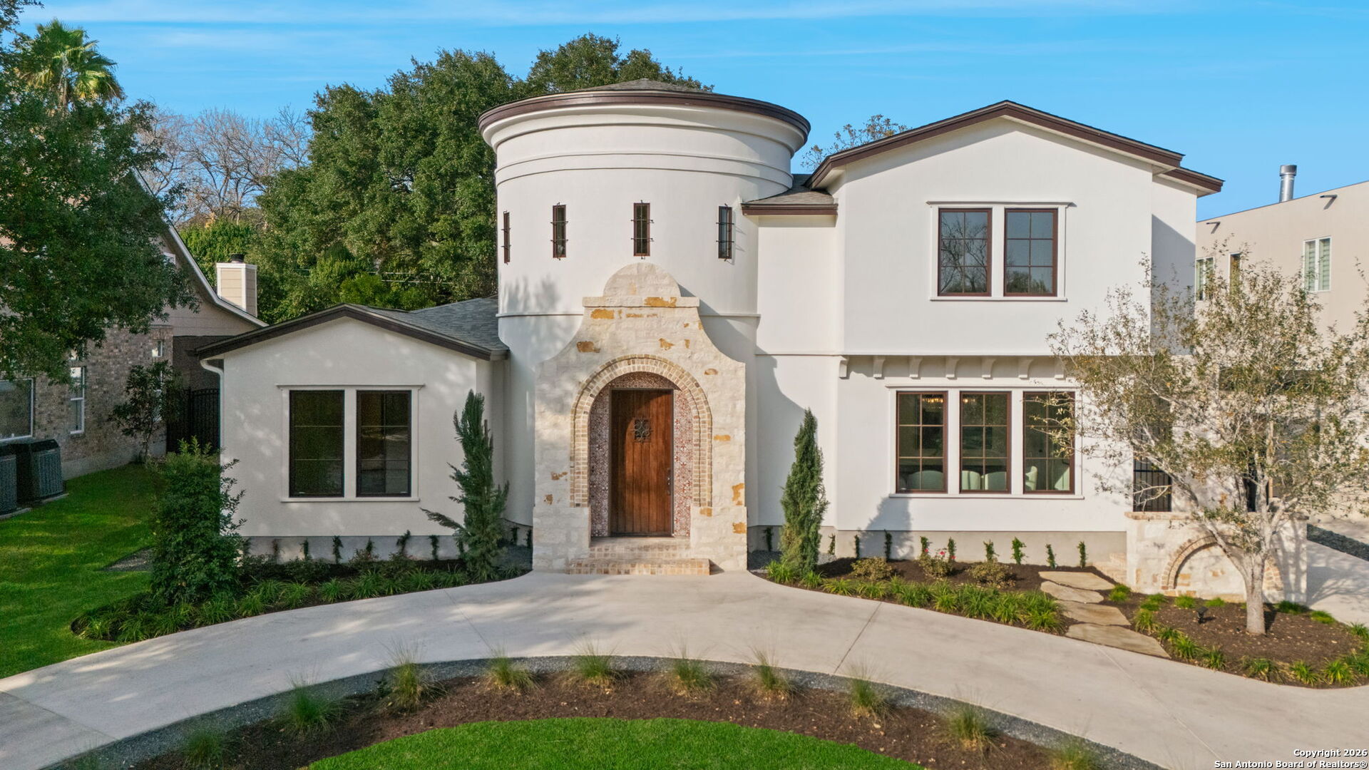 Welcome to 817 Garraty, a masterfully crafted new construction residence in the heart of Terrell Hills, where timeless architecture meets refined modern luxury. Thoughtfully designed for elevated living, this exceptional home showcases impeccable craftsmanship, soaring ceilings, and an abundance of natural light throughout. A grand rotunda makes a striking first impression, seamlessly opening to an expansive Great Room anchored by a fireplace-perfect for entertaining and intimate evenings. The open-concept layout flows effortlessly into the gourmet kitchen, beautifully appointed with luxury finishes, Thermador appliances, and a well-designed butler's pantry, while a separate dining space creates the ideal setting for memorable gatherings. The main level offers exceptional comfort and privacy, featuring a serene primary retreat with spa-inspired bathroom details, along with a well-appointed guest suite complete with an en-suite bath. A dramatic wrought-iron spiral staircase leads to the second level, where two additional bedrooms, two bathrooms, and two expansive flex rooms provide versatility for a private office, game room, fitness studio or fifth bedroom. Outdoors, the private backyard offers ample space for a swimming pool and outdoor entertaining, complemented by a detached garage that enhances both privacy and functionality. With its expansive layout, luxury finishes, and enduring design, 817 Garraty presents a truly elevated living experience.