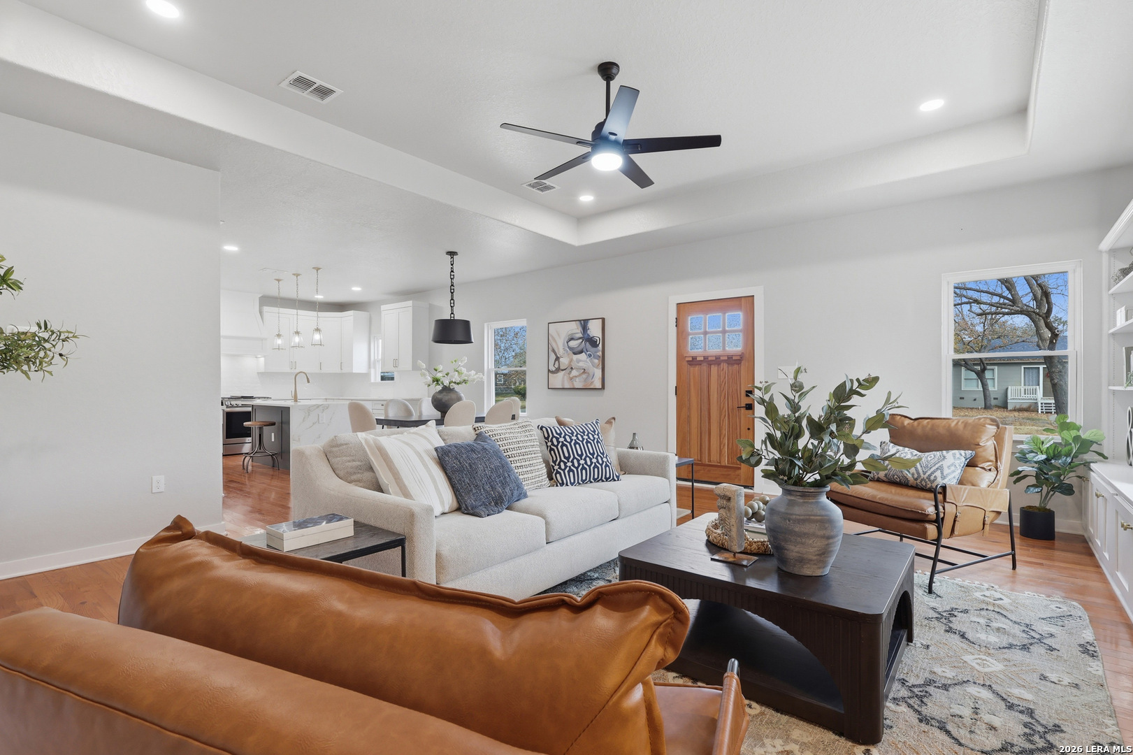 Located in desirable Terrell Heights within coveted Alamo Heights ISD, this timeless residence has been thoughtfully reimagined from the studs with no detail overlooked. The renovation includes new plumbing, roof and roof pitch, spray-foam attic insulation, and beautiful hardwood floors throughout.  The light-filled interior showcases 10-foot coffered ceilings, custom cabinetry, quartz countertops, and high-end finishes at every turn. The serene primary suite offers a spacious sitting area, double closets, and private patio access, while the additional bedrooms feature walk-in closets. Exterior upgrades include an oversized new driveway and carport, enhancing both curb appeal and everyday convenience. The home is offered with a new French door refrigerator, dishwasher, and microwave, making it truly move-in ready. Timeless character meets fresh, modern living in one of San Antonio's most sought-after neighborhoods. Offered below recent appraisal due to seller relocation, with pre-listing due diligence available for buyer review.