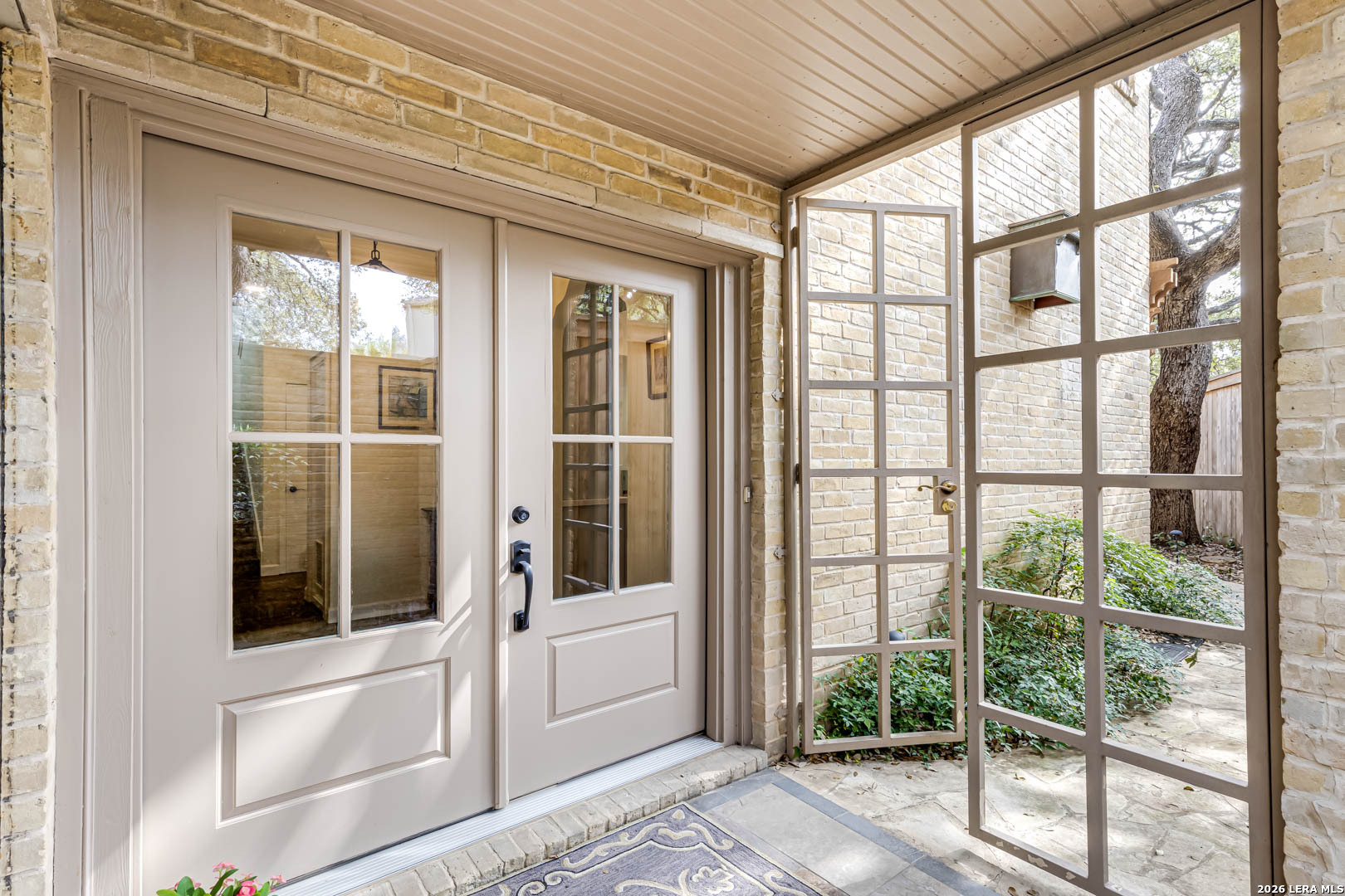 Beautifully updated luxury townhome in prime Alamo Heights location. White oak floors run throughout the main living spaces and bedrooms, adding warmth and cohesion. The gourmet kitchen showcases a generous island, professional gas range, paneled refrigerator, prep sink, and undercounter microwave, flowing effortlessly into the dining area and the impressive two-story living room surrounded by windows. Sliding glass doors open to the pool on one side and a private patio on the other for effortless indoor-outdoor entertaining. The tranquil primary suite features a statement accent wall, walk-in closet, and spa-inspired bath with a large shower, dual vanity and Anthropologie mirrors. Pre-plumbed ready for a future soaking tub. Ideally positioned near premier dining, shopping, downtown San Antonio, and the airport.