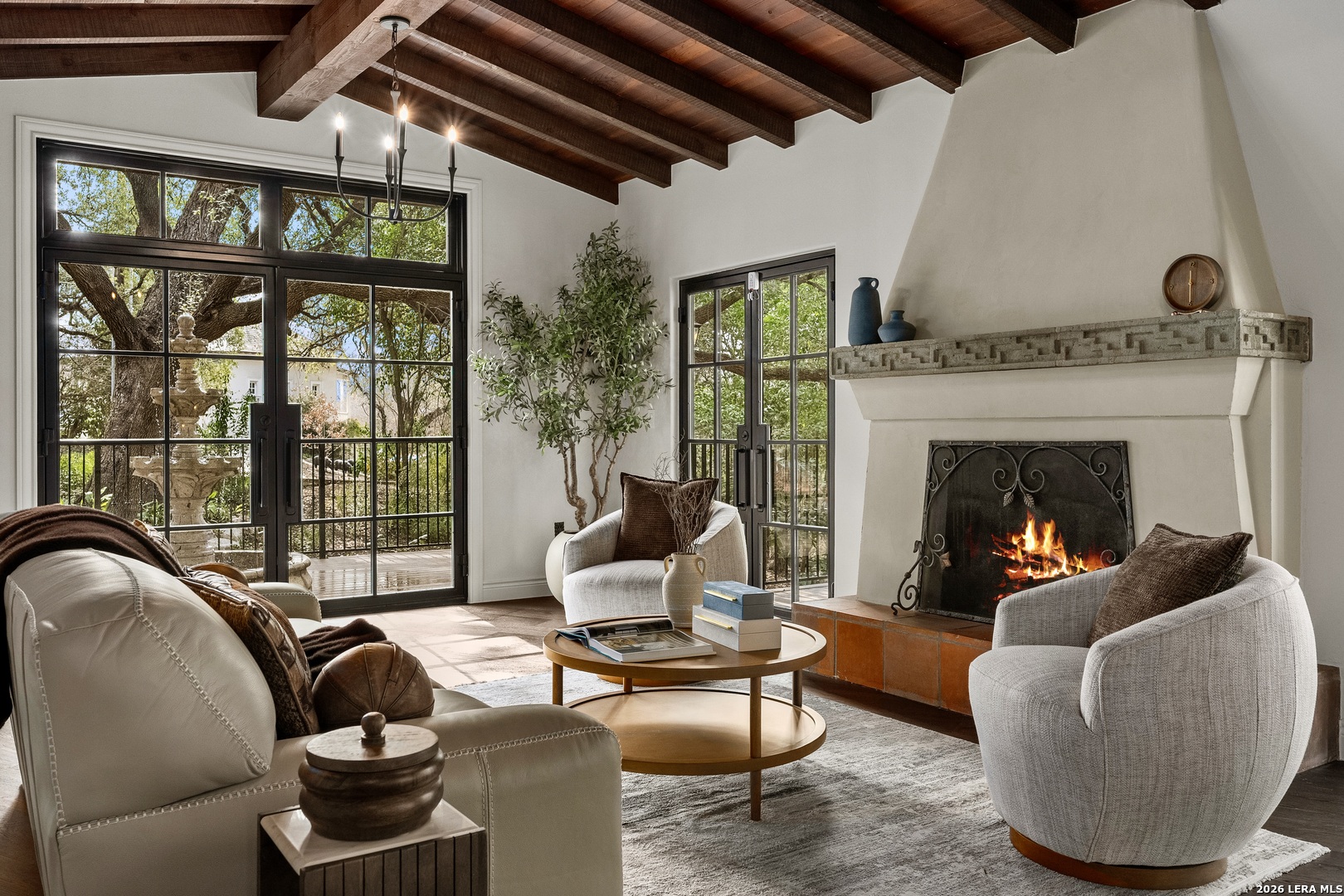 Villa del Bosque - Alamo Heights. Set beside the wooded edge of Olmos Basin and adjacent to 3.25 acres of green space, 215 Canyon Dr. sits quietly within one of the most serene settings in Alamo Heights. Majestic oak trees, filtered light, and natural privacy frame the home, creating a rare connection between architecture and landscape. Originally designed by architect Harvey P. Smith, the residence reflects a period when homes were composed for permanence - with thick walls, deep overhangs, and interiors arranged to respond naturally to climate, light, and daily living. The home was thoughtfully restored and expanded by Dave Isaacs Homes, preserving its architectural integrity while extending its livability for modern use. Interior spaces are defined by generous proportions, natural light, and a calm material palette that complements the surrounding forested setting. Living areas open toward the landscape, creating a seamless flow between indoor comfort and the quiet presence of the park beyond. Villa del Bosque offers a rare opportunity to live beside one of San Antonio's most treasured natural corridors while enjoying the character, craftsmanship, and enduring design of a home rooted in architectural tradition. Stucco, timber, shadow, and time - held in balance.