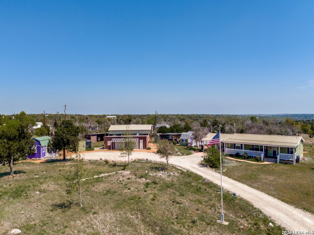 Rare 22 acre unrestricted development opportunity on Ranch Road 965, one of Fredericksburg's premier tourism corridors. Just 15 minutes from Historic Main Street and Enchanted Rock, with 375 feet of frontage and an estimated 500,000-700,000 vehicles passing annually. Existing improvements include a 3BR/2BA residence, metal shop (propane and 220 volt electric available), powered outbuildings, backup generator, additional electric meter, signage, rainwater collection and RV shelter with hookups. Ideal for hospitality, glamping, events, recreation, RV, commercial or mixed-use development. Wildlife exemption in place; subdivision may be possible. Exceptional location, infrastructure and flexibility.