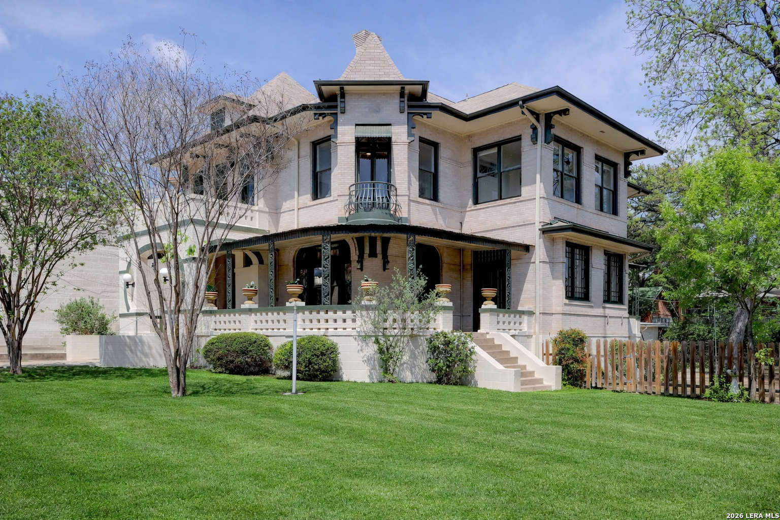 Welcome to the relaunch of 109 E Woodlawn! This 1907 Victorian Home in the heart of Monte Vista presents an exceptional opportunity for short-term rental investment thanks to its unbeatable location-just steps from La Fonda on Main and surrounded by popular restaurants, bars, local shops and the Pearl District. The property also offers wonderful potential as a primary residence, featuring a spacious backyard with ample room to add a pool and create your own private retreat, plus the proximity to the highly rated Keystone School. This stunning Victorian home offers 4,820 square feet of timeless character, featuring 5 bedrooms and 4 bathrooms, all situated on a spacious third-acre lot. From the moment you step inside, you're welcomed by an elegant entry adorned with original stained glass, beautifully handcrafted millwork, parquet flooring, and a striking architectural grand staircase. The rich woodwork continues into the living room, highlighted by original stained glass windows and a classic fireplace. French glass pocket doors lead into the formal dining room, where the history of the home truly shines-showcasing intricate wood detailing, a coffered ceiling, a custom mural, and a built-in buffet. Adjacent to the dining room is what was traditionally a conservatory, originally designed to ventilate the home and nurture plant life, adding to the home's historic charm. The main level also features a kitchen, full bathroom, and a versatile bonus room ideal for a bedroom or office, along with a hidden bookshelf door that opens to a spacious storage closet. Upstairs, the primary suite is a private retreat, complete with original built-in cabinetry, a sitting area, and an en-suite bath. Step out onto the balcony to take in views of the downtown San Antonio skyline. The upper level also includes three additional bedrooms, two bathrooms, and a bonus room that opens to a second conservatory space. Recent updates include a fully repainted exterior (preserving the original brick), fresh interior paint throughout, four HVAC units with new ductwork, and updated electrical systems-blending modern comfort with historic elegance.