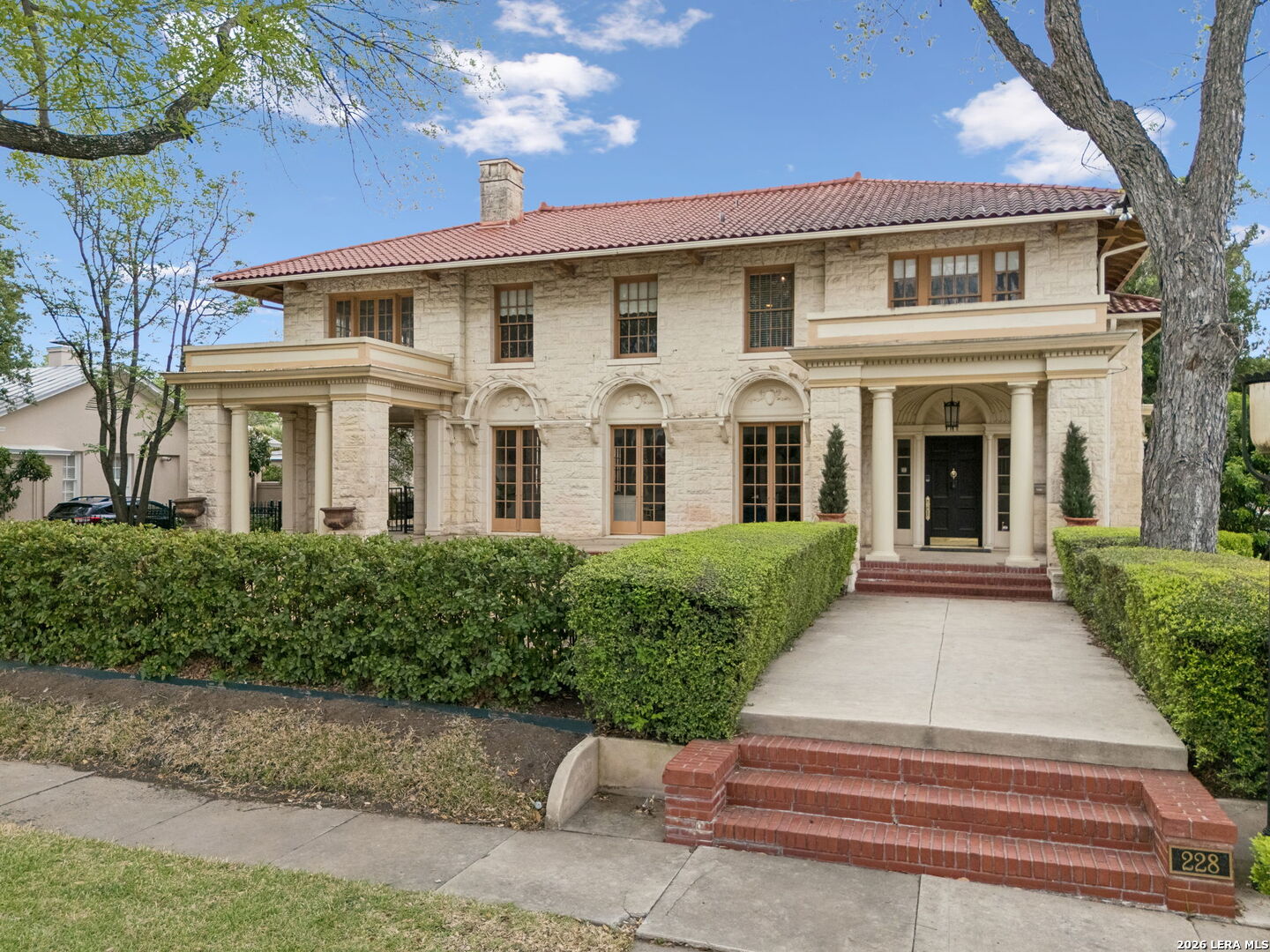 Crafted by noted architect Atlee B. Ayres, 228 W Mulberry is situated on a prominent corner lot in the Monte Vista Historic District of San Antonio. Originally built in 1917, this historic residence offers over 5,100 square feet of refined living space, where architectural integrity has been thoughtfully maintained alongside select modern updates. The home's floorplan is designed for both everyday living and entertaining, featuring generously scaled rooms, approximately 10-foot ceilings, and a seamless flow between interior and outdoor spaces. French doors open onto wraparound patios, creating multiple areas for gathering and extending the living experience outdoors. Upstairs balconies provide additional vantage points and outdoor access, further enhancing the home's design and functionality. Original architectural elements remain intact and are complemented by updates over time, offering a balance of historic character and modern livability. The property features a limestone exterior, mature trees, and multiple covered outdoor living areas, along with a detached two-story guest house of approximately 1,100 square feet. The guest house is permitted for short-term rental use; buyer to verify current city regulations, permitting, and any future compliance requirements. Located in a well-established central San Antonio neighborhood, the property offers convenient access to Downtown, the Pearl, the San Antonio Zoo, and San Antonio International Airport, as well as nearby dining and coffee destinations including Capparelli's on Main, Barbaro, La Fonda on Main, and Merit Coffee. Nearby schools shown in public real estate data include St. Anthony Catholic School, San Antonio Academy, and Keystone School; buyers should independently verify school options, attendance eligibility, and distances. This is a rare opportunity to own a property attributed to Atlee B. Ayres, combining architectural significance, flexible living space, and a sought-after Monte Vista location. All information to be verified by buyer.