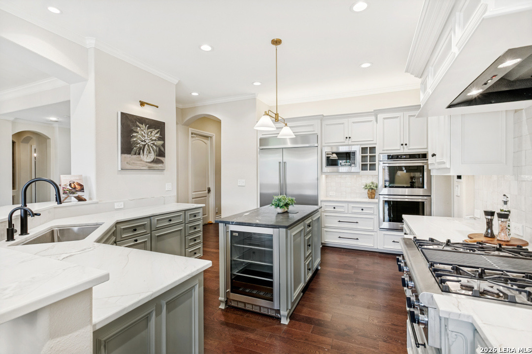 Welcome to a beautifully renovated estate nestled in the heart of Terrell Hills and situated within the highly sought-after Alamo Heights Independent School District. The recent updates include a stunning grand staircase, a modernized kitchen, and a luxurious primary bathroom, creating an elegant atmosphere throughout.  Boasting seven spacious bedrooms, six full baths, and two half baths, this home offers ample space for family and guests. The main living level provides multiple living and dining areas, a dedicated office, and a private guest suite with a full bath. Upstairs, you'll find the primary suite, four additional secondary bedrooms, and a cozy living area perfect for relaxing or entertaining.  The lower level is designed for enjoyment, with a full kitchen, an expansive game room, and a vibrant bunk room. Step outside to the backyard oasis, where a sparkling swimming pool and outdoor kitchen.   Car enthusiasts will fall in love with the two oversized garages (attached two-car and detached three-car), offering plenty of parking and storage space, as well as upgraded electrical and EV charging. Above the detached garage is a two-bedroom, one-bath apartment featuring its own kitchen, living area, and laundry room-ideal for extended family or guests.  This exceptional property also offers a unique opportunity to purchase the adjacent .68-acre lot, expanding your estate even further.