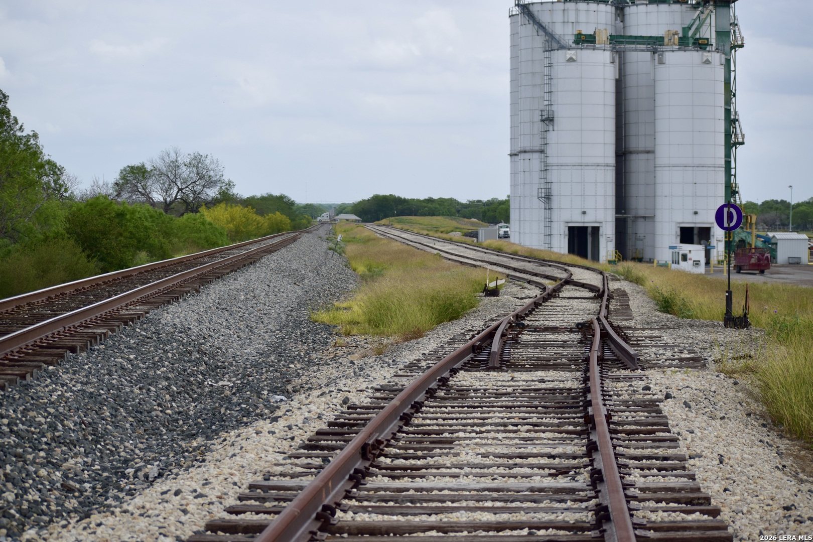 Rail served industrial property located at 657 FM 99 in Whitsett, Texas offering approximately 27 acres with direct access to the Union Pacific rail line. Originally developed as a frac sand transload facility, the site features multiple large capacity vertical storage silos, conveyor systems, and truck load out infrastructure designed for high volume bulk material handling.    The property includes loop track configuration and multiple rail spurs allowing for efficient rail to truck transloading operations. Improvements on site provide significant value and reduce redevelopment costs for a variety of industrial uses.    Strategically located in South Texas with convenient access to US 281 and within proximity to the Eagle Ford region, the property is well positioned for industrial users requiring rail access and large scale outdoor storage or logistics operations.    Ideal for frac sand, aggregate distribution, cement or fly ash terminal, oilfield services, or other rail served industrial applications.