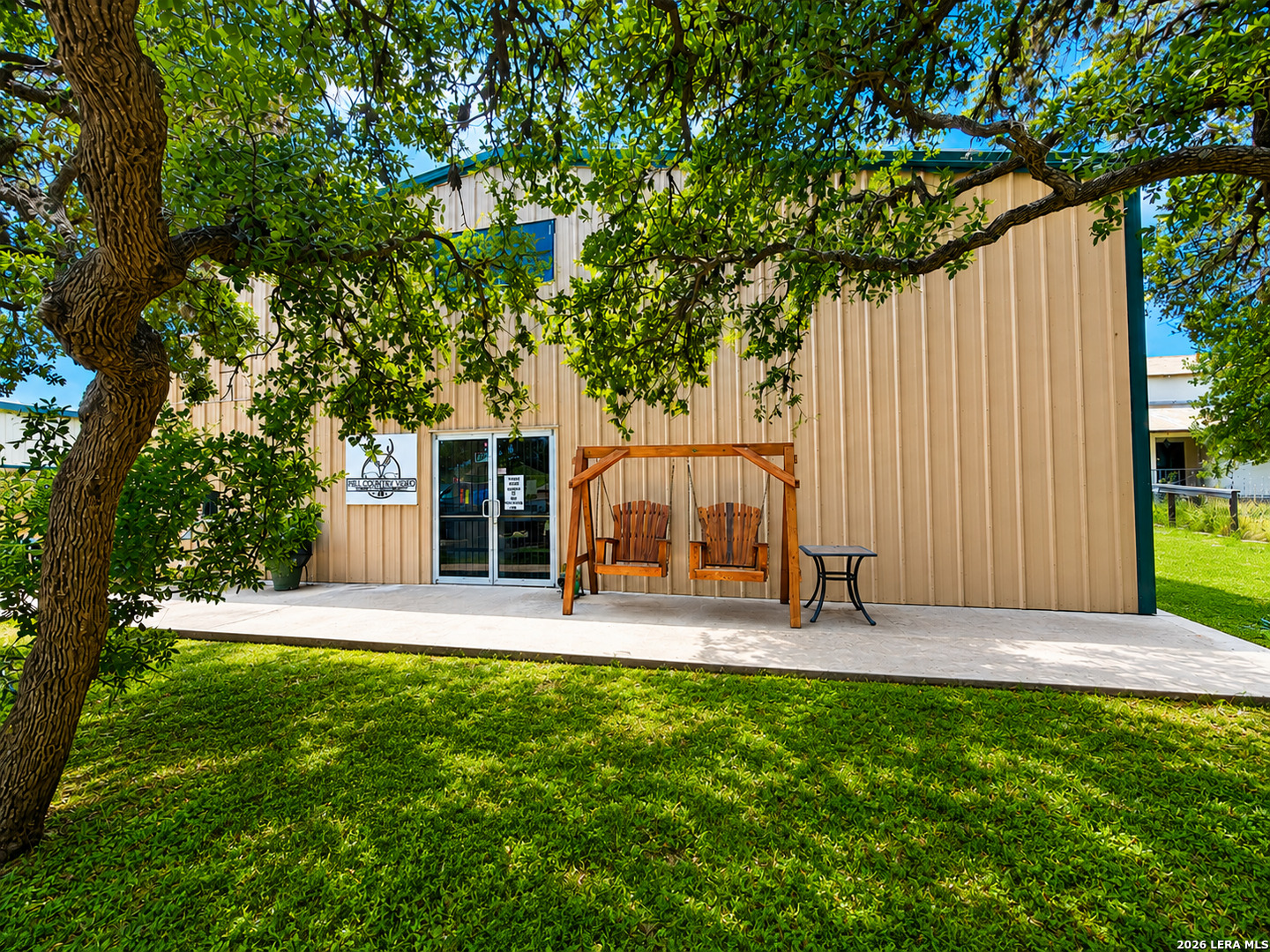 Introducing 206 On The Nueces - a distinctive mixed-use commercial opportunity in the heart of Camp Wood, just blocks from the Nueces River. Offering approximately 7,000+  SF of flexible space on approximately 0.26 acre, this metal-and-steel property is well suited for an owner-user, investor, entrepreneur, or business seeking a versatile Hill Country location.    The main level provides expansive commercial space with potential for retail, showroom, office, workshop, production, service, storage, or other business concepts, along with convenient ground-level loading access and multiple functional areas that can be adapted to a variety of operational needs.    An additional 1,600 SF (approx.) of second-floor residential space adds exceptional flexibility for an owner/operator, on-site management, guest accommodations, or supplemental use. The residence includes an open-concept kitchen, dining and living area, two bedrooms, two full baths, pantry, and primary walk-in closet. Downstairs 3rd bd/1.5 ba option available.  Located in the heart of the Nueces Canyon, the property benefits from proximity to the Nueces River and a scenic area known for camping, hunting, outdoor recreation, state parks, and Hill Country tourism. A rare opportunity to combine commercial functionality, residential convenience, and investment potential in one property.    Square footage, measurements, property features, permitted uses, and other information are approximate and/or seller-provided. Buyer to independently verify all information and suitability for intended use.