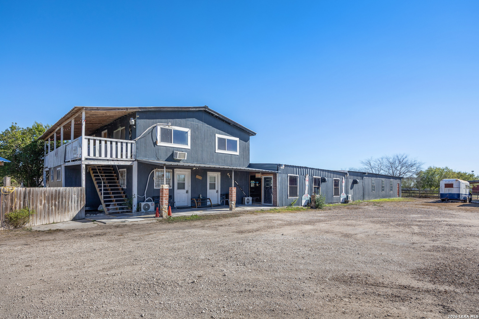 Mixed-use residential and commercial opportunity on approximately 5+/- acres, w/multiple existing income streams w/significant upside for expansion. The property features a large dance hall/event space (not currently operating) that was previously licensed for alcohol sales, making it ideal for revival as an event venue, entertainment space, or adaptive commercial use. Behind the dance hall is a horse arena, adding flexibility for agricultural, recreational, or event-related use. The property includes RV hookups, three septic systems, and a private well, supporting multiple structures and future development. Residential improvements include, and a three-unit studioplex that has recently operated as short-term rentals/Airbnb. This layout allows for a blend of owner occupancy, long-term leasing, short-term rentals, or employee/vendor housing. With ample open land remaining, the property offers room to expand with additional cabins, RV pads, event infrastructure, or other income-producing improvements (buyer to verify use and permitting). OWNWER FINANCING AVAILABLE WITH A 20% DOWN PAYMENT.